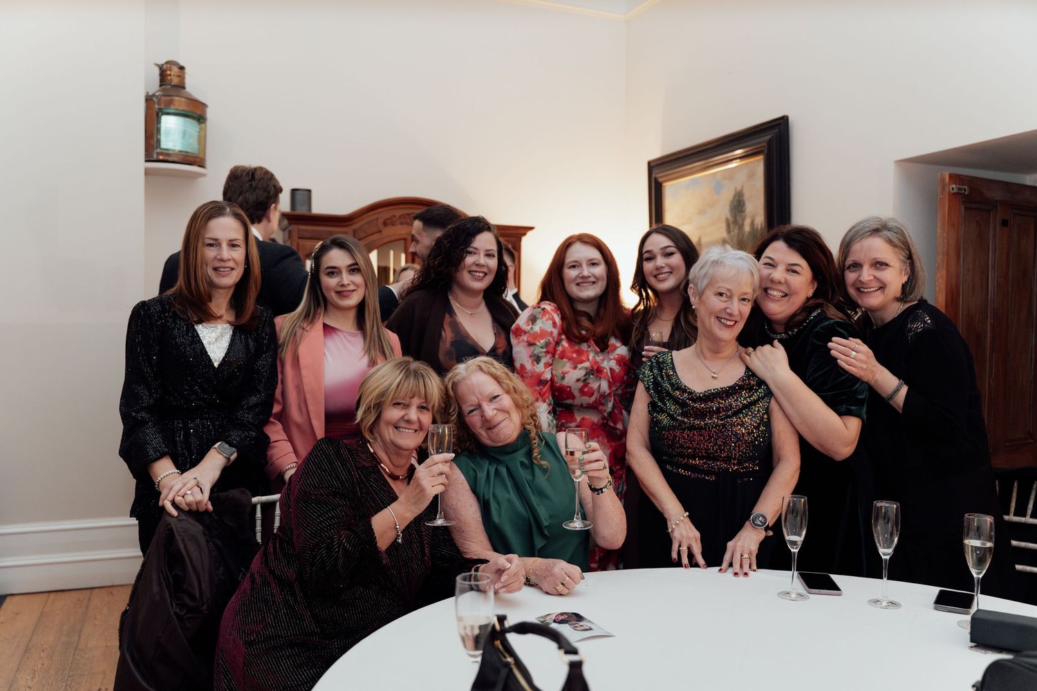 Group of wedding guests gathered together for candid moments at a celebration.