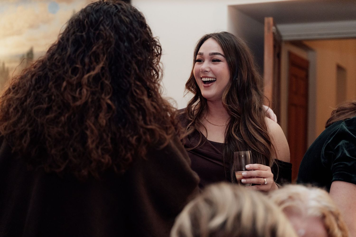 Candid moments of laughter and celebration captured during a wedding reception.