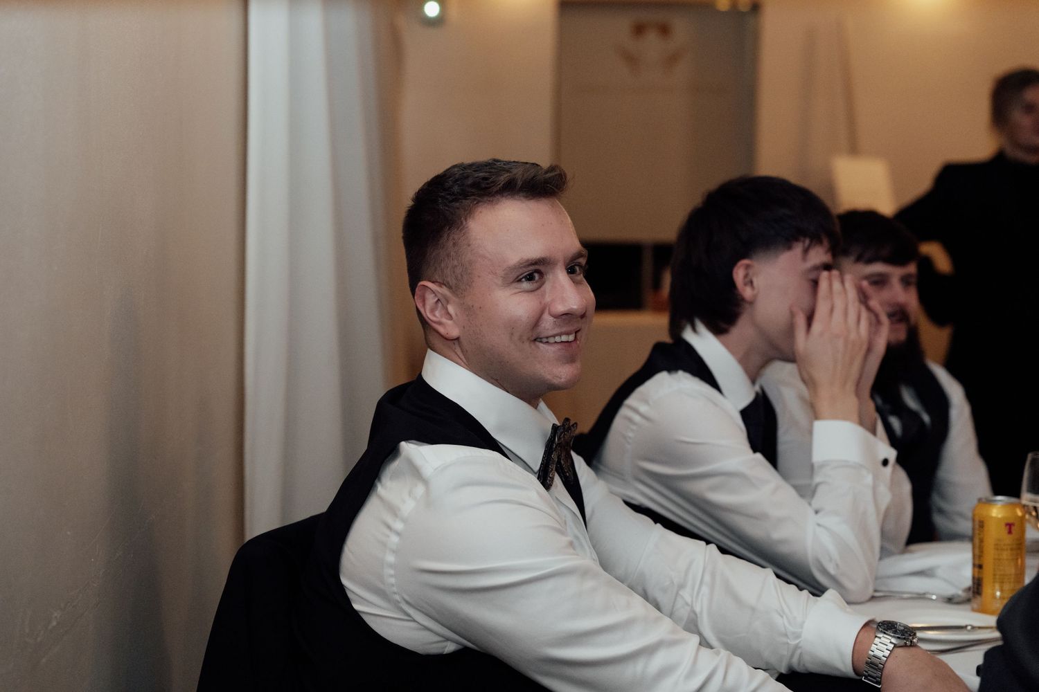 Wedding party members enjoying themselves during the reception dinner festivities.