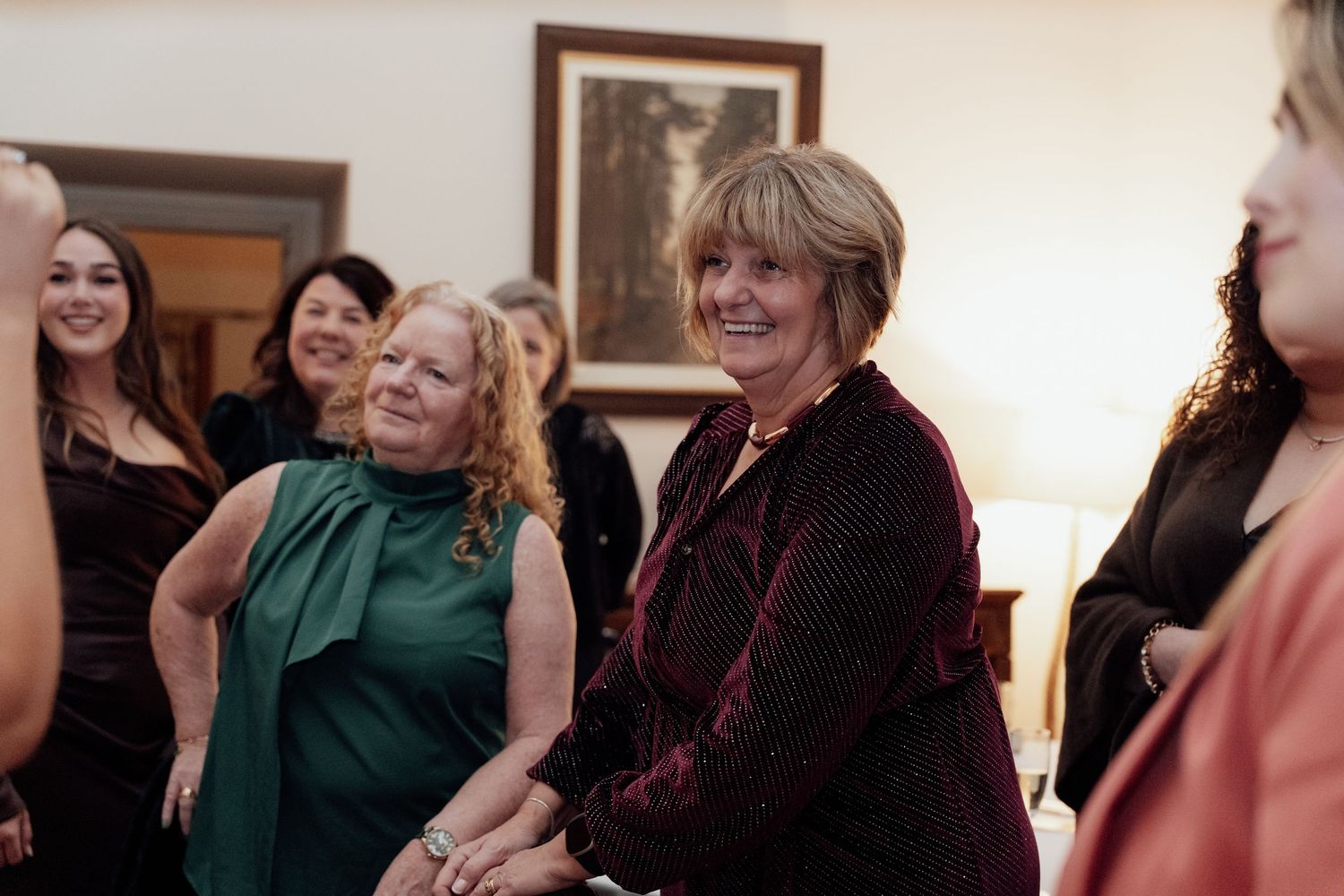 Wedding guests share joyful reactions during an emotional moment at a celebration.