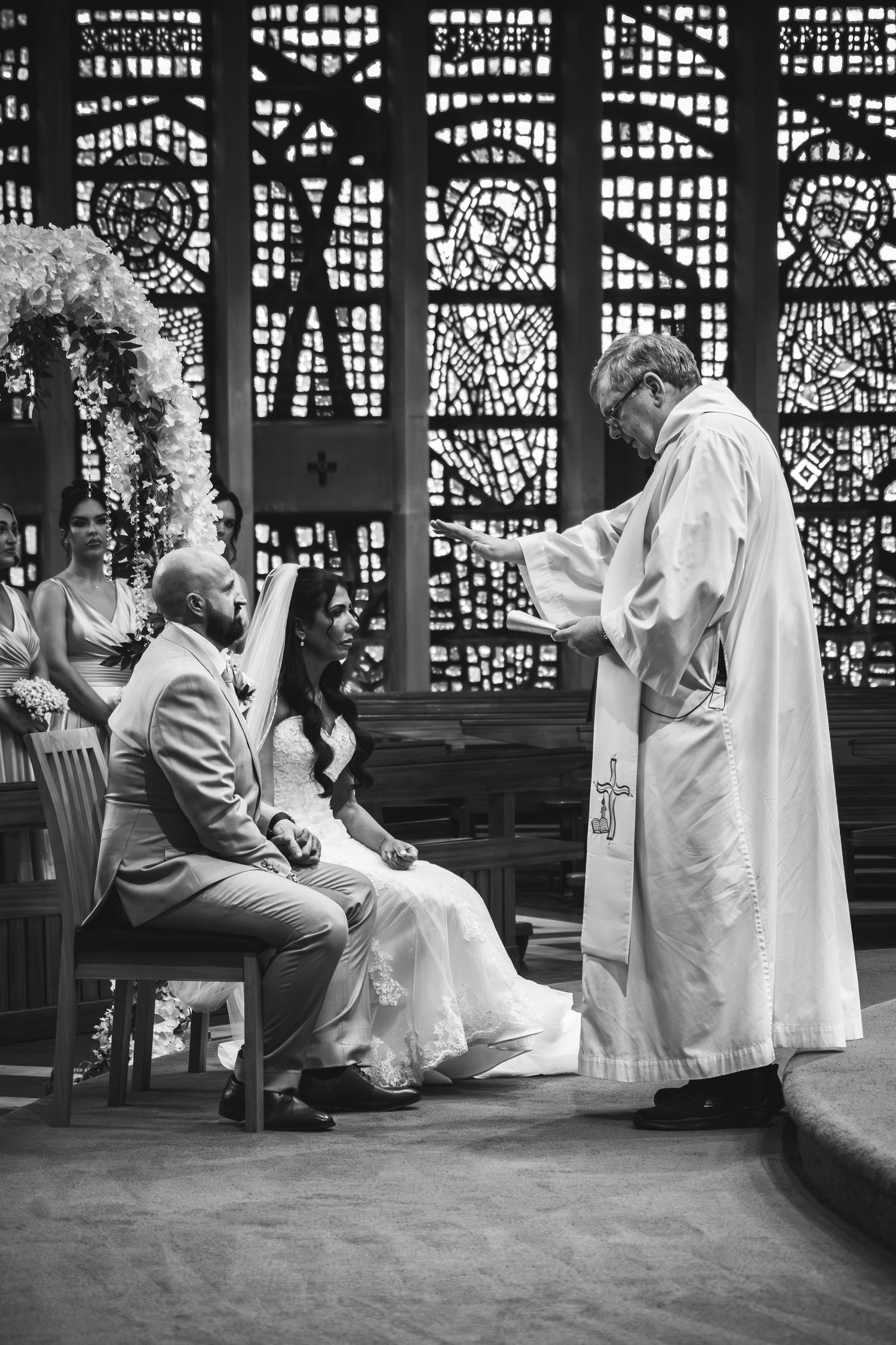 A sequence of black and white photos showing a couple dancing and twirling in a vintage-style setting with patterned windows.
