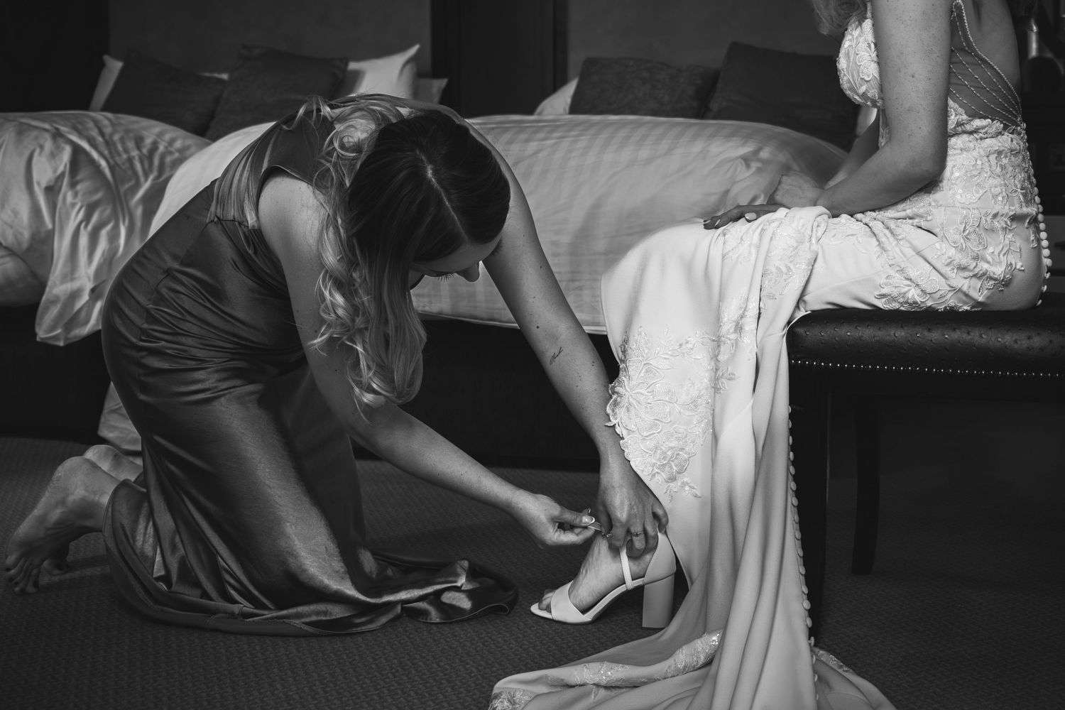 People in dark clothing lie on the floor during what appears to be a performance or exercise session.