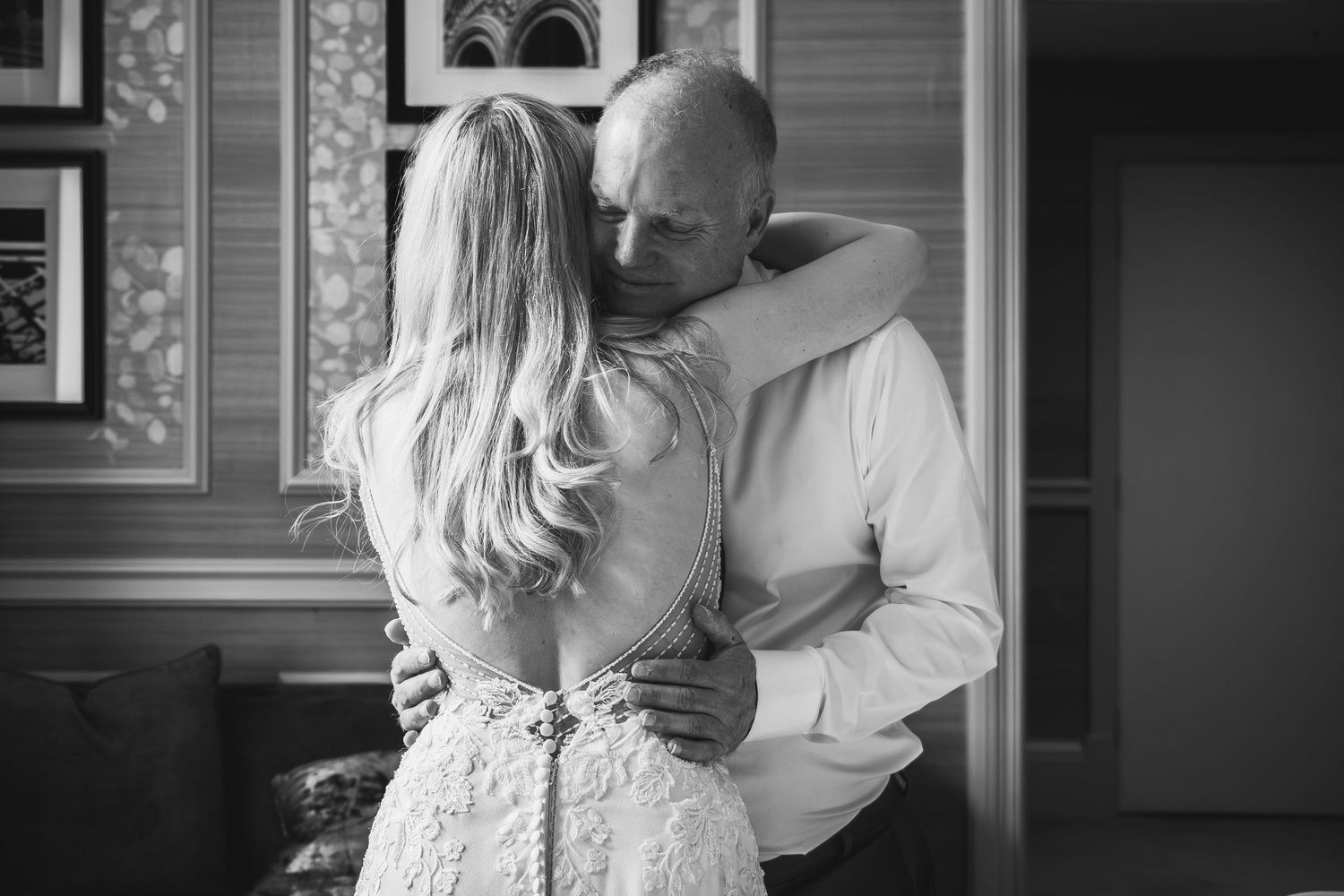 Black and white image of two people embracing in an intimate moment.