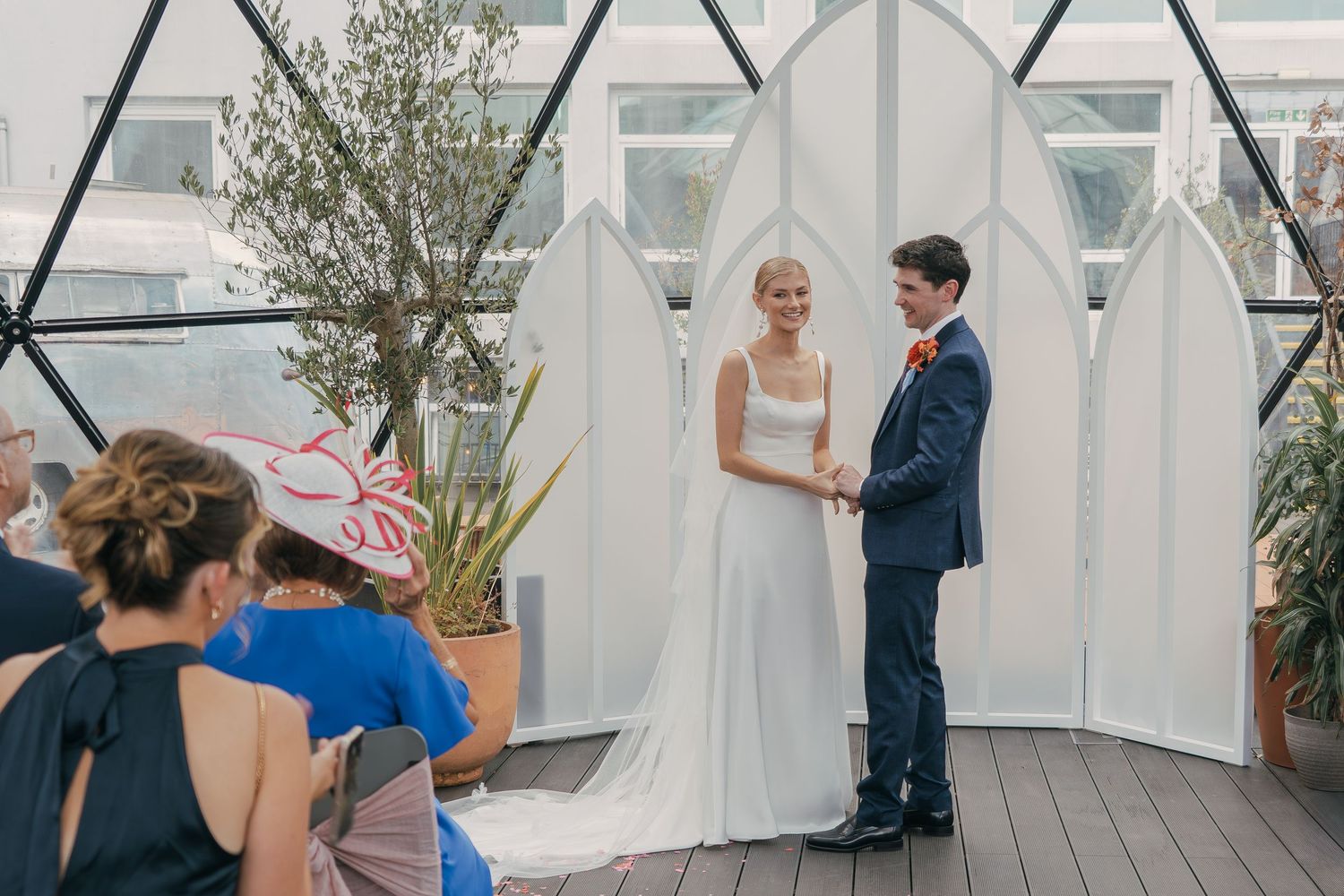A series of wedding reception photos showing guests dancing and celebrating on an outdoor deck with white tent canopies.