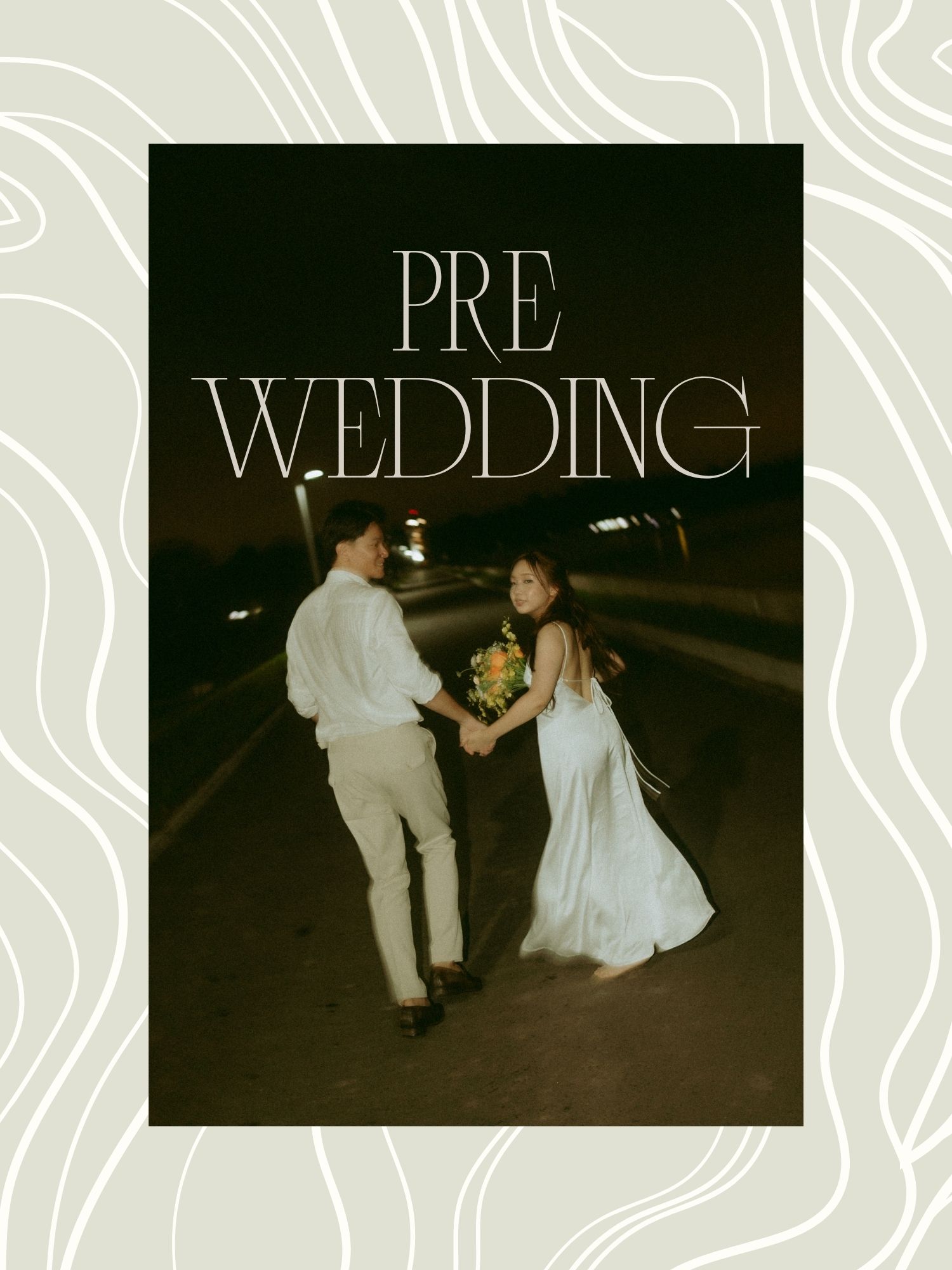 Pre-wedding photo of a couple holding hands on a road at night, woman in white dress holding yellow flowers.