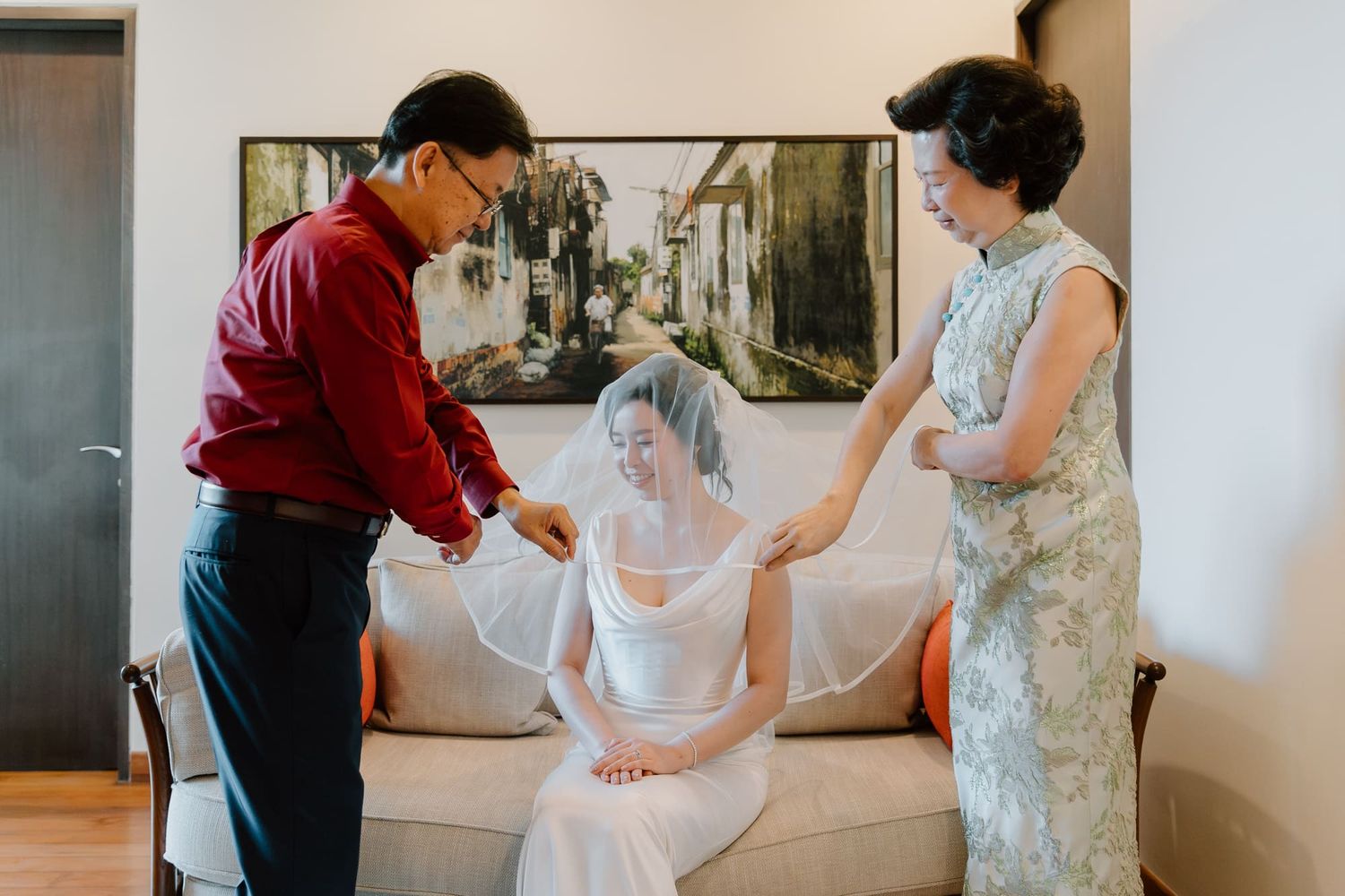 A series of images showing preparations for a wedding ceremony with people helping adjust a white dress.