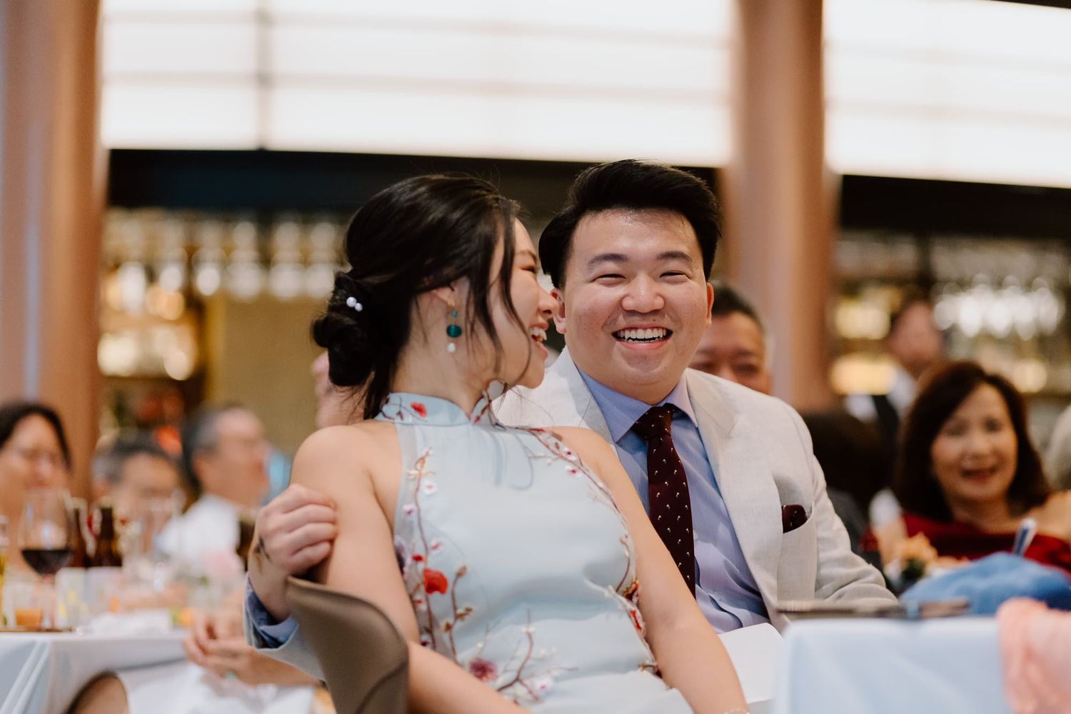 Couple sharing intimate moment during wedding reception dinner.