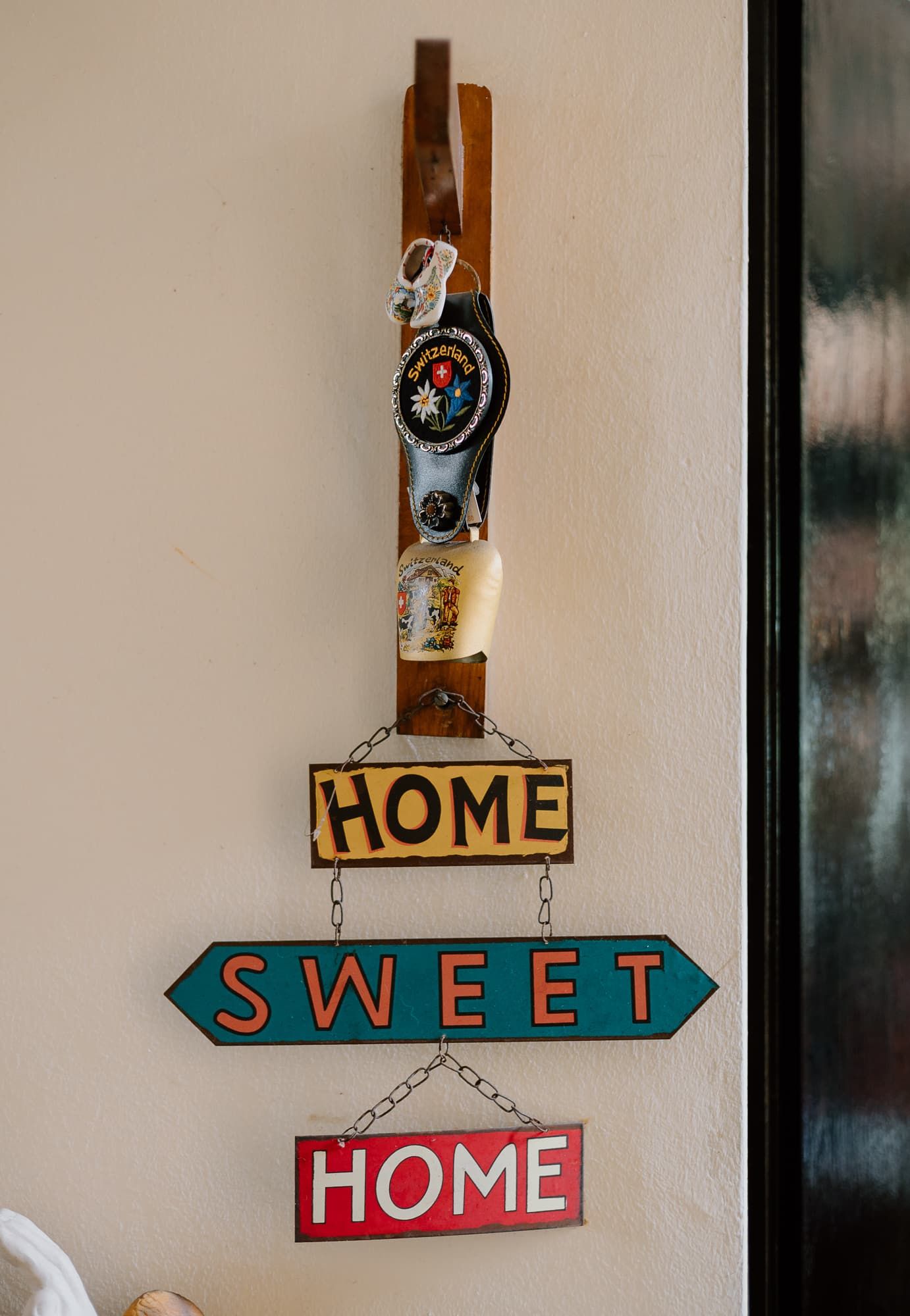 A decorative 'Home Sweet Home' sign mounted on a beige wall.