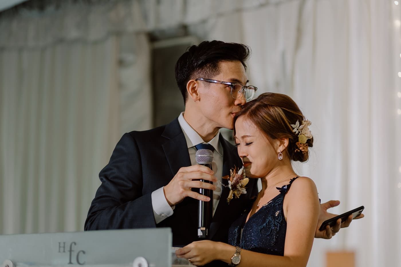 Intimate wedding reception moment with string lights and white decor creating a romantic ambiance.