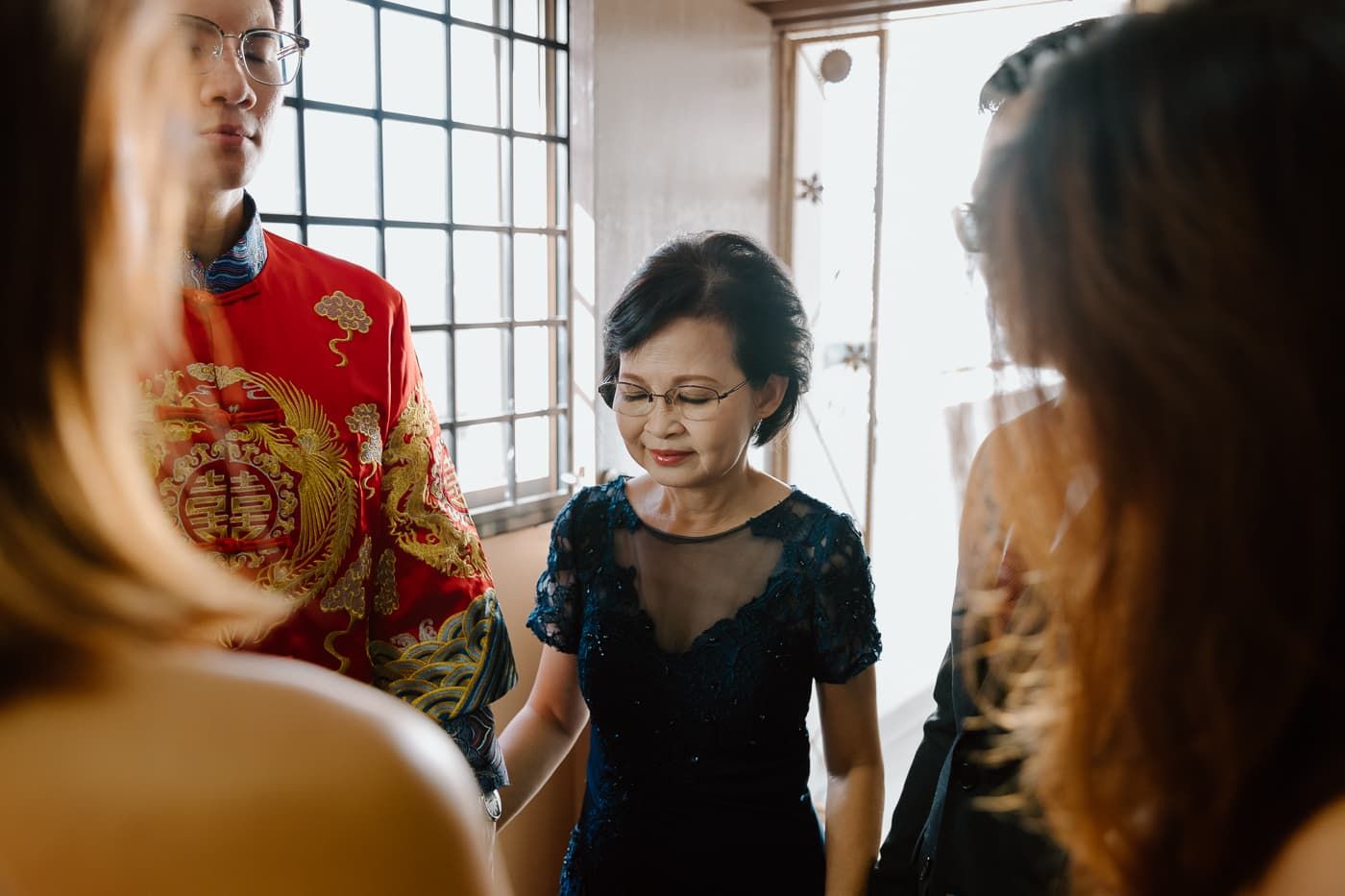Traditional Chinese wedding ceremony with guests in formal attire.