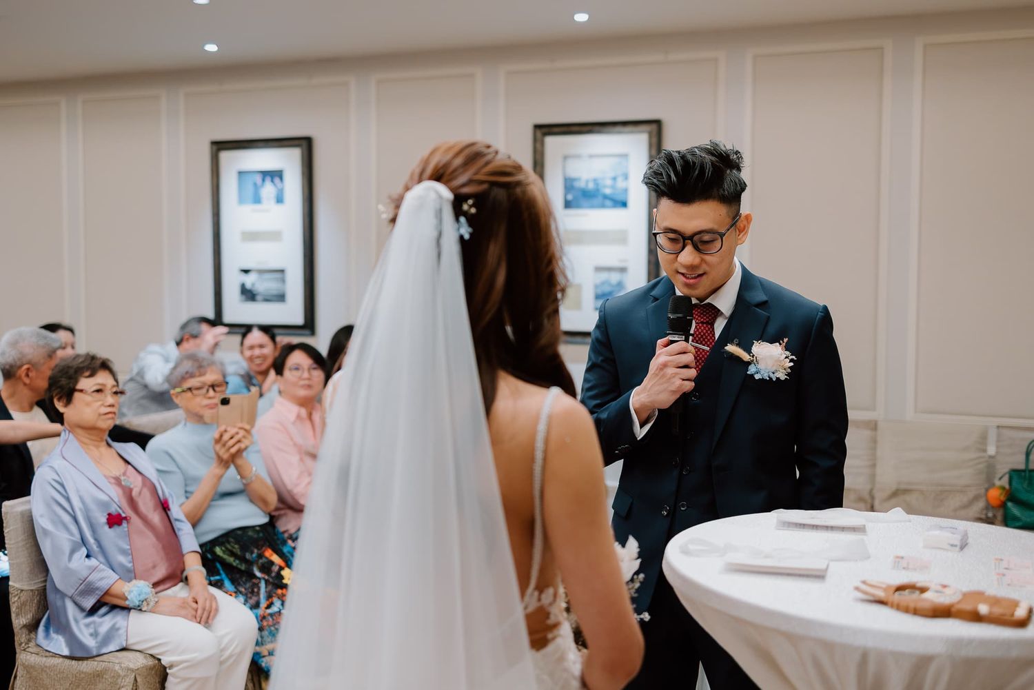 Emotional wedding ceremony moment with guests watching as couple shares their vows.
