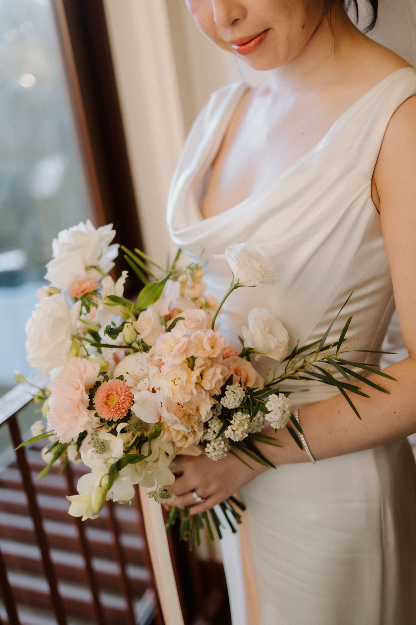 Elegant bridal bouquet featuring soft peach and white flowers with delicate greenery shown in a series of close-up detail shots.