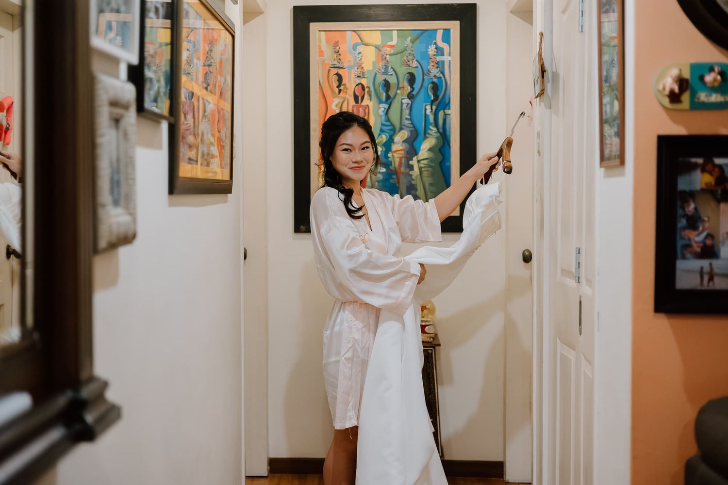 An elegant gathering space decorated with framed artwork on light walls.