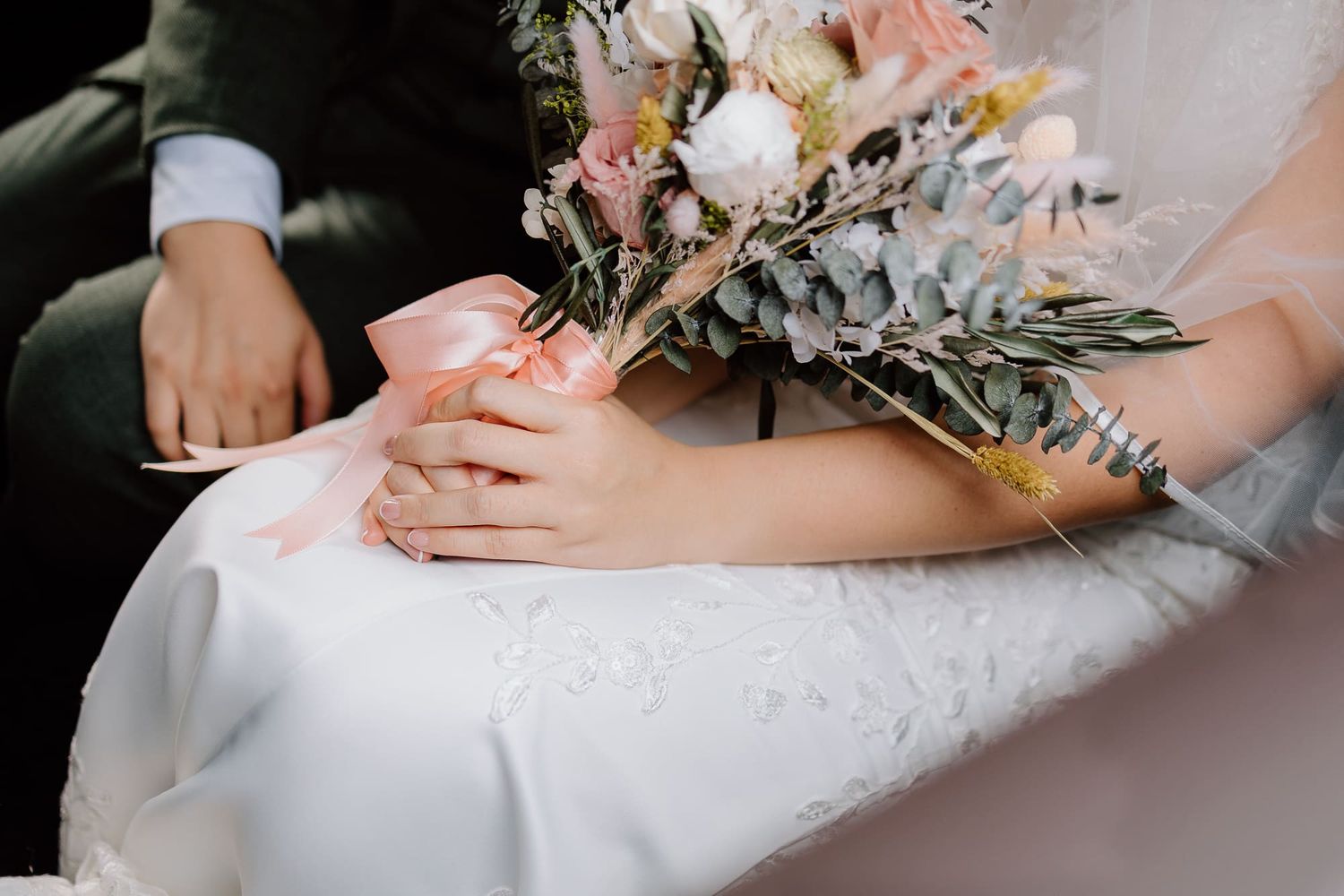 White wedding gown details with delicate floral bouquet arrangements.