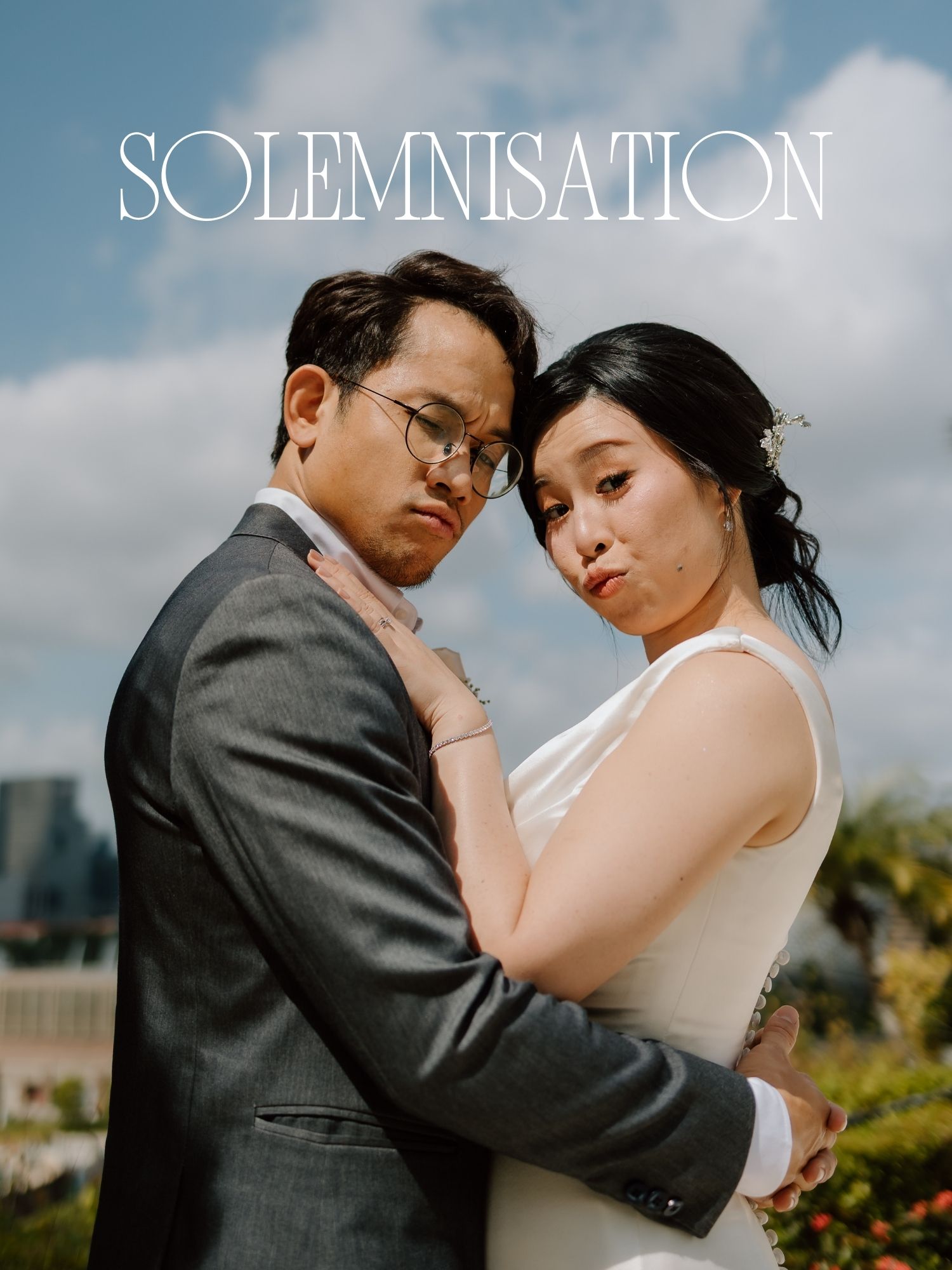 Asian couple in wedding attire embrace outdoors under cloudy sky, with SOLEMNISATION text overlay.