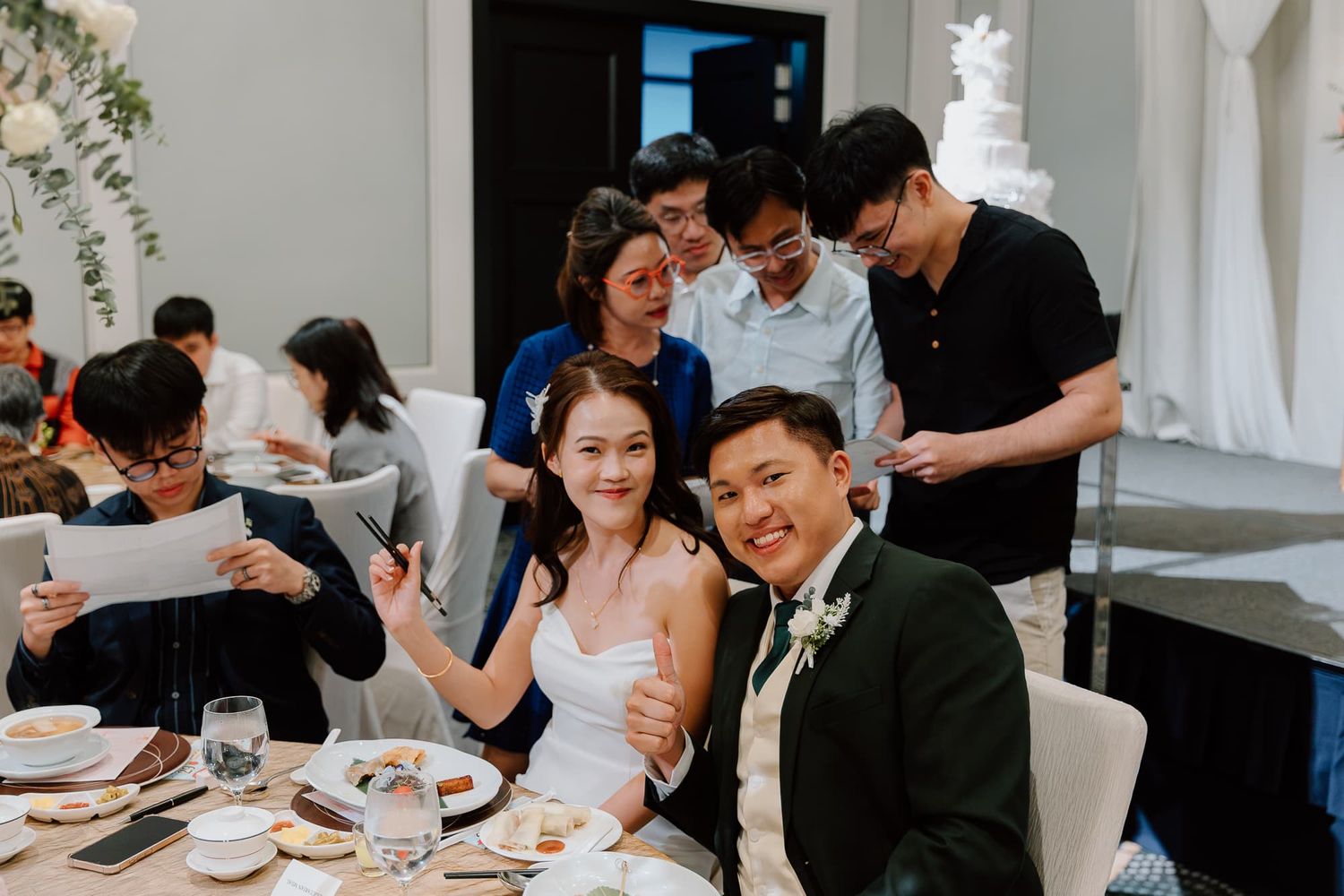 Wedding reception guests enjoying conversations at decorated dining tables.