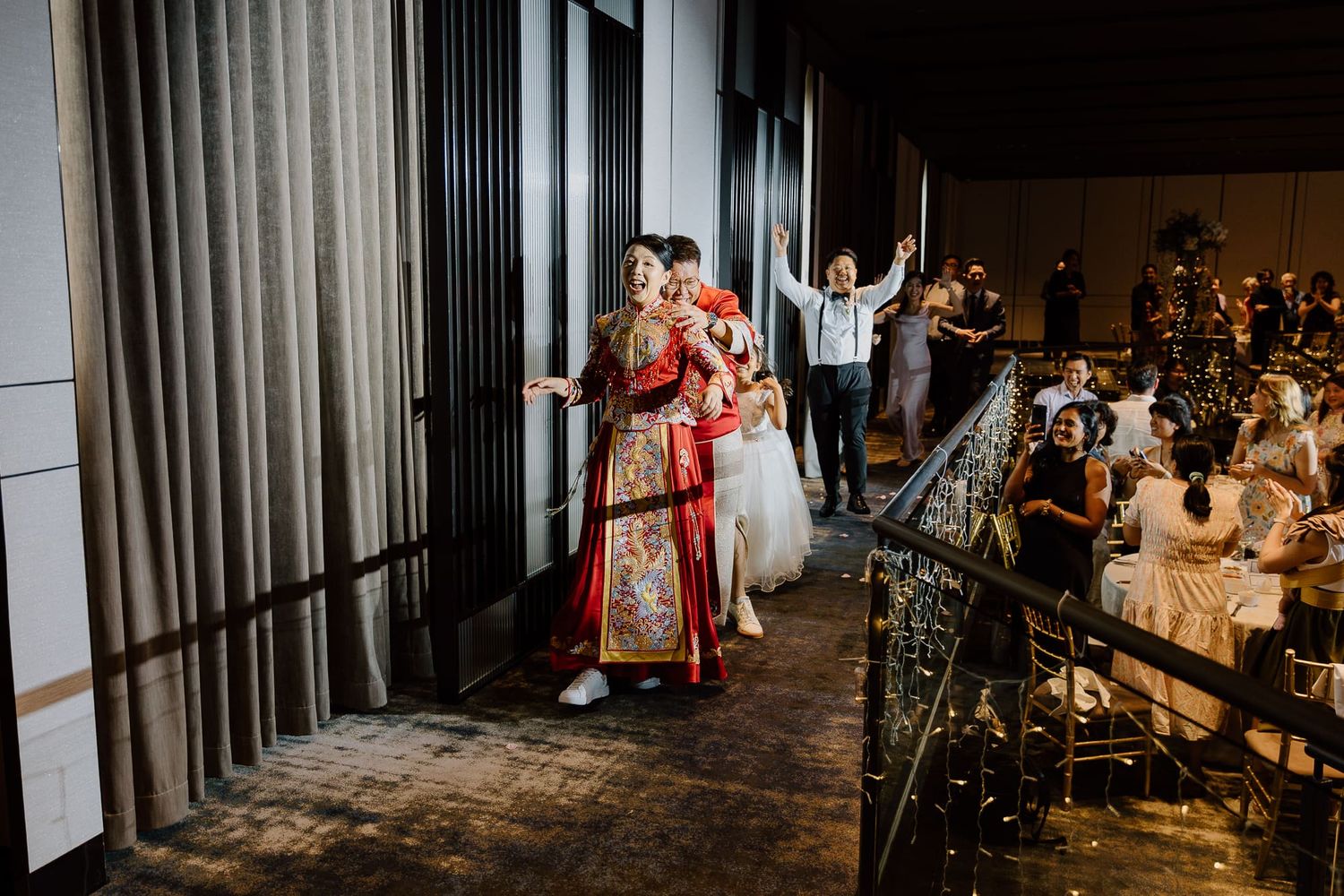 Dance floor celebration with wedding guests gathered around the couple during their first dance at an elegant venue.