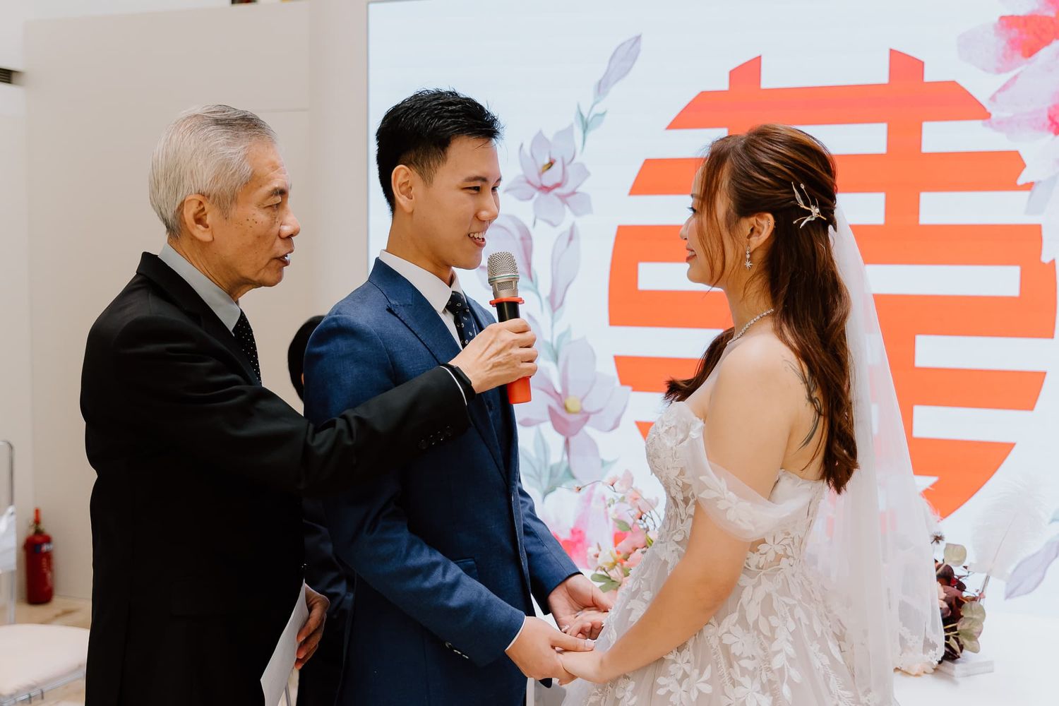 Wedding ceremony moments captured in bright venue with decorative backdrop.