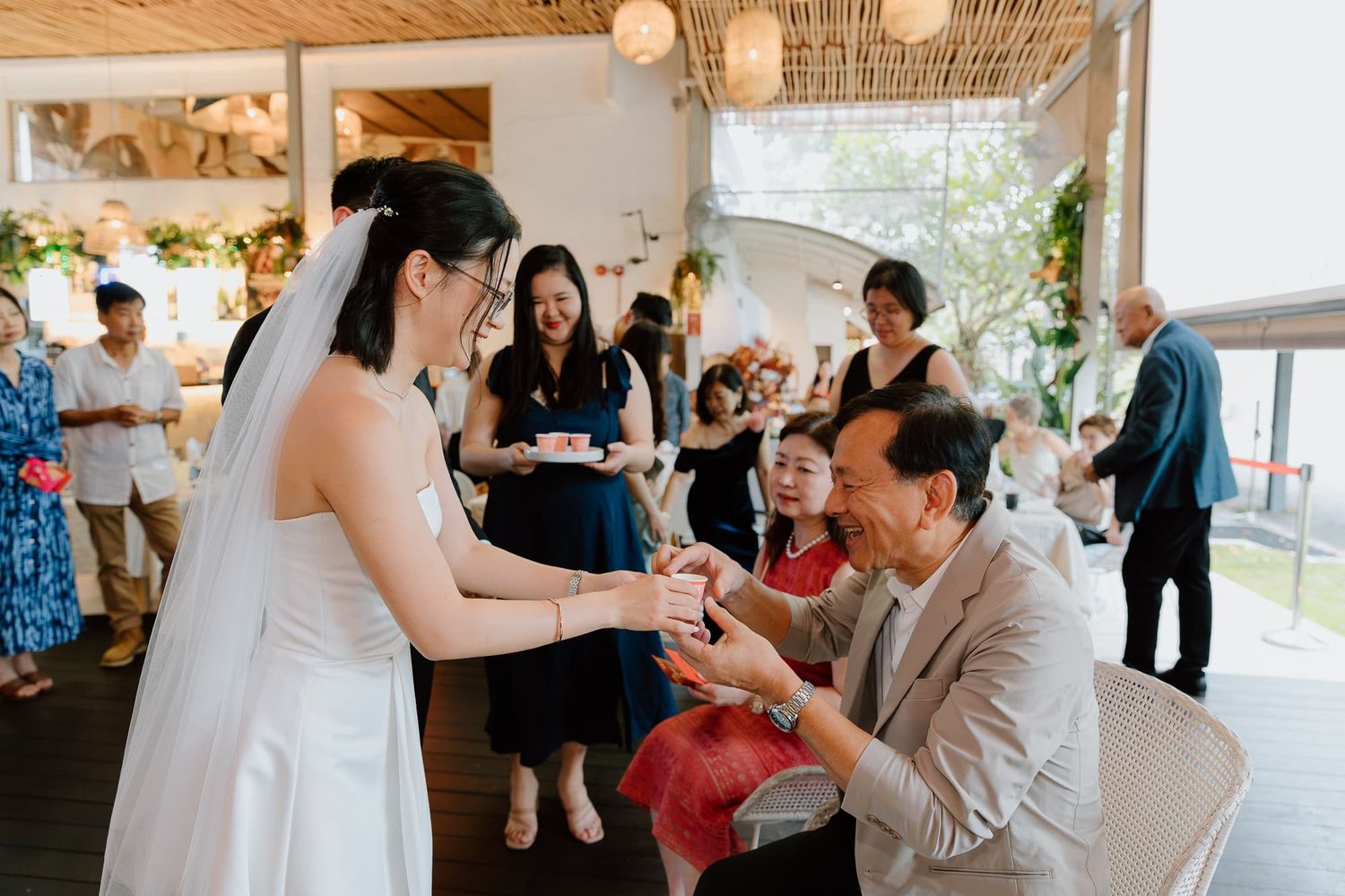 Wedding celebration moment with guests and bride sharing heartfelt interaction.