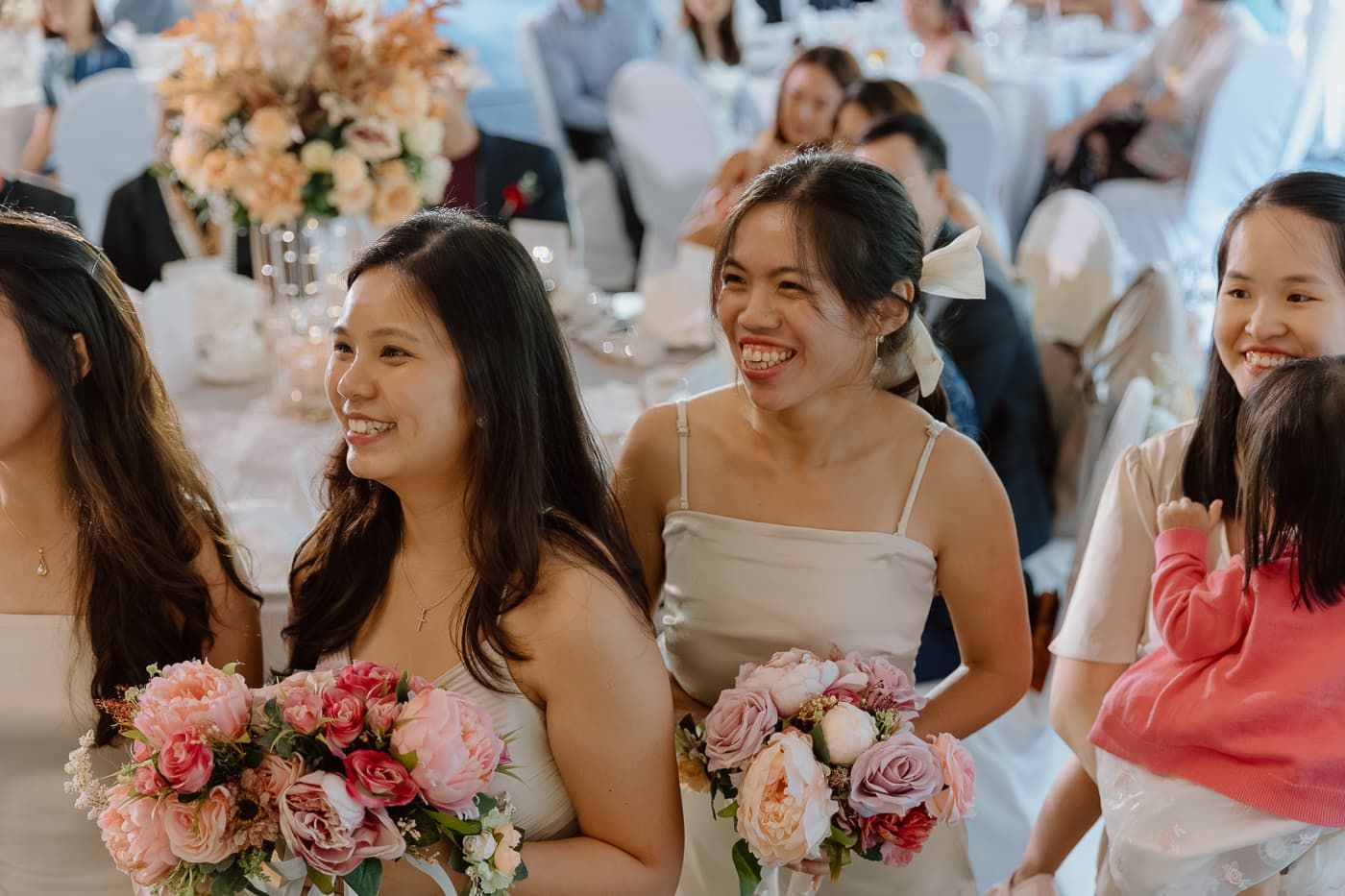 Wedding guests enjoying celebrations at an indoor reception.