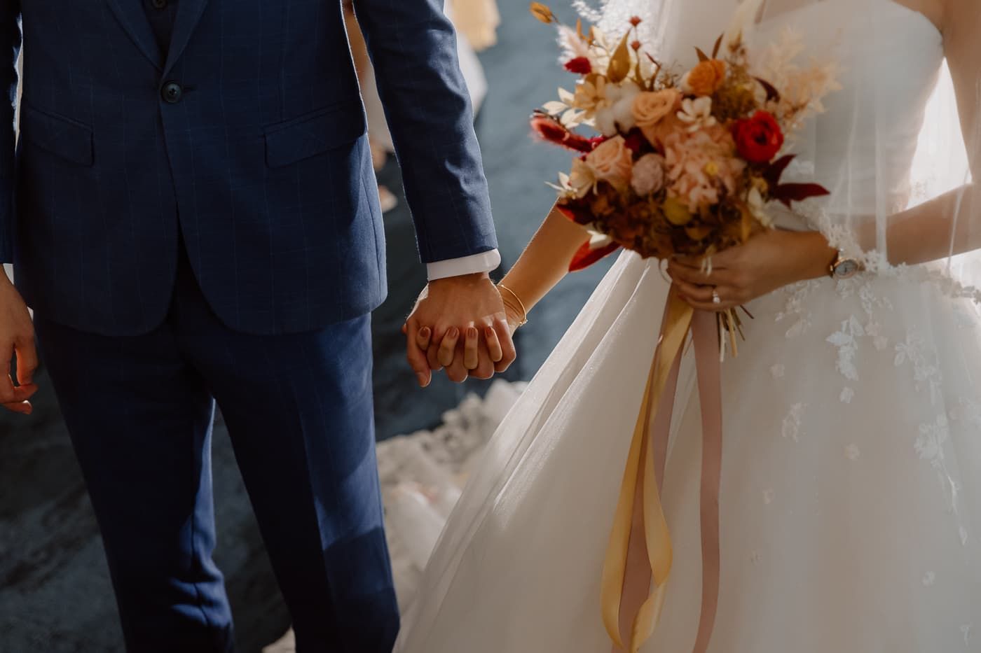 Intimate wedding moment captured during ceremony with elegant floral decor.