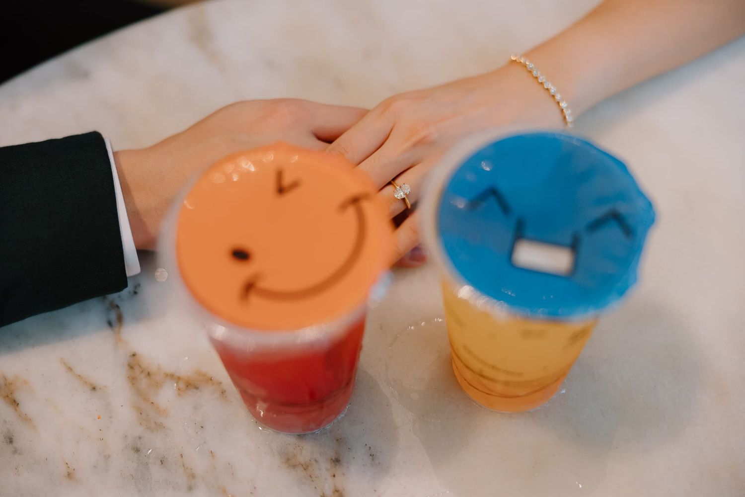 Colorful smiley face desserts arranged on a white surface at a wedding reception.