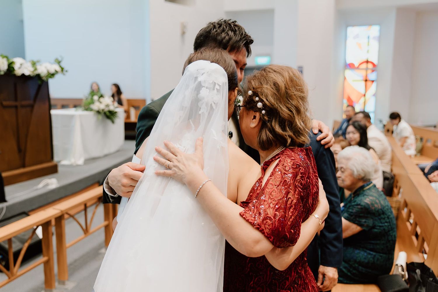 Wedding celebration featuring guests dancing and interacting at an indoor reception venue.