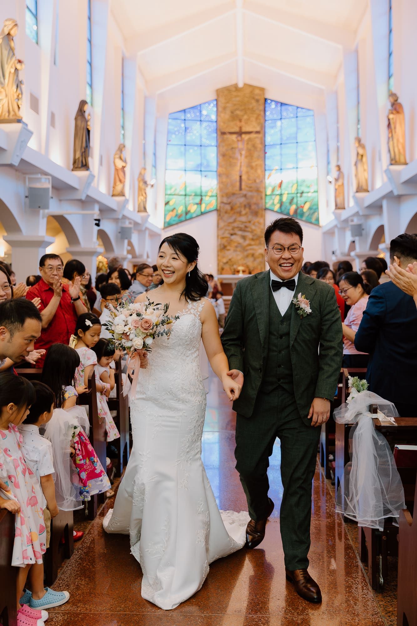 A lively dance party scene in a bright church reception hall with guests celebrating on the dance floor.