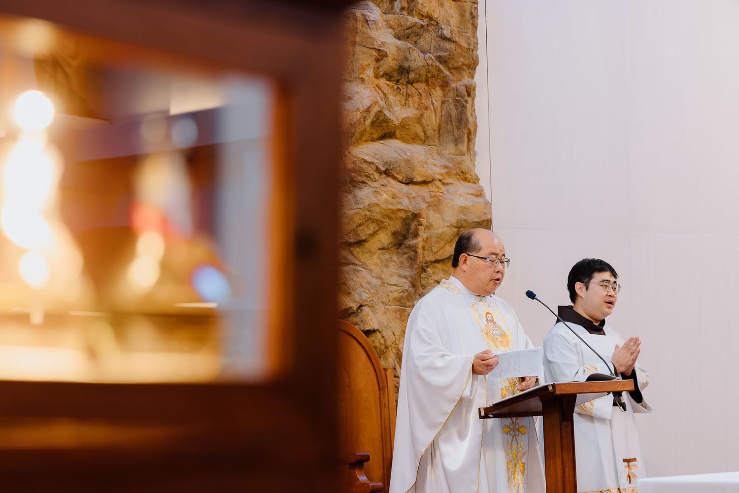 Priests or clergy members standing at an altar during a religious ceremony.