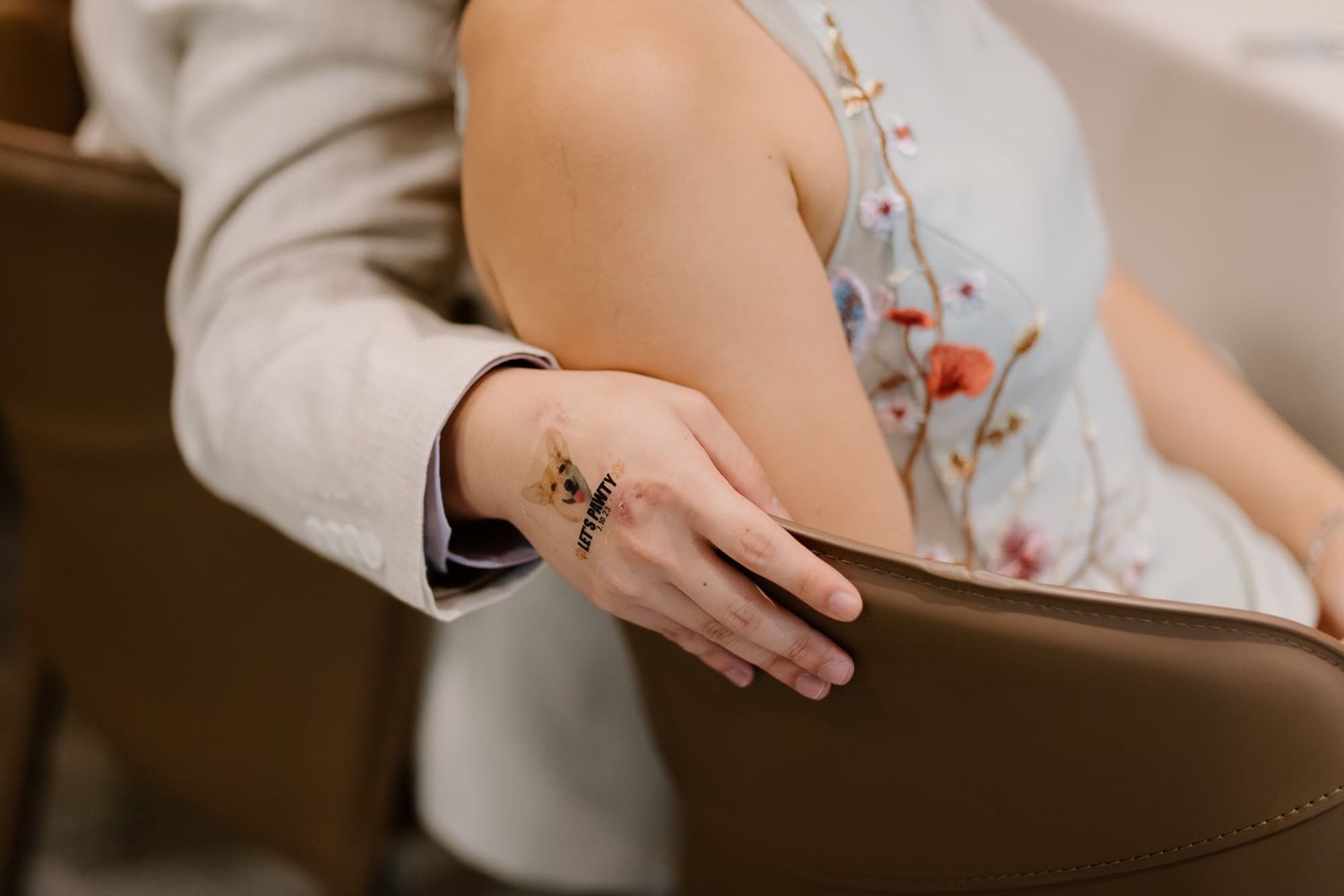 Close-up of delicate floral embroidery detail on wedding attire.