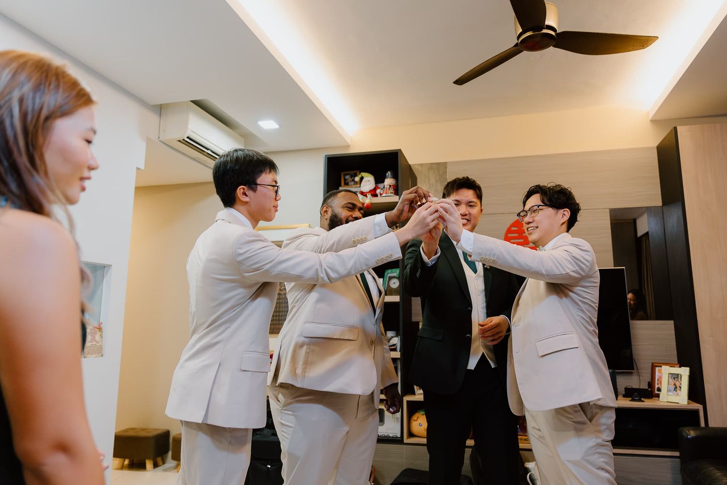 Wedding party members dancing and celebrating in a modern indoor venue.