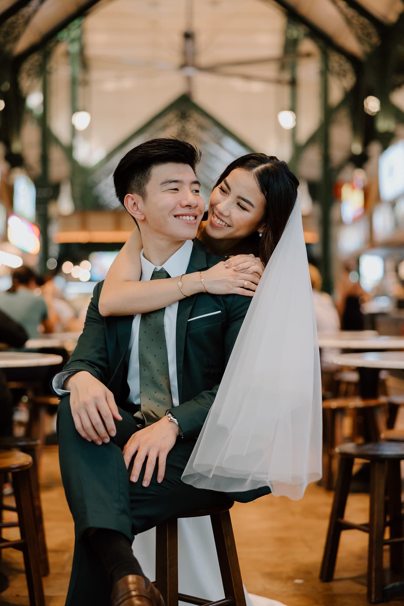 Candid wedding photos captured in a warm indoor venue with romantic lighting.