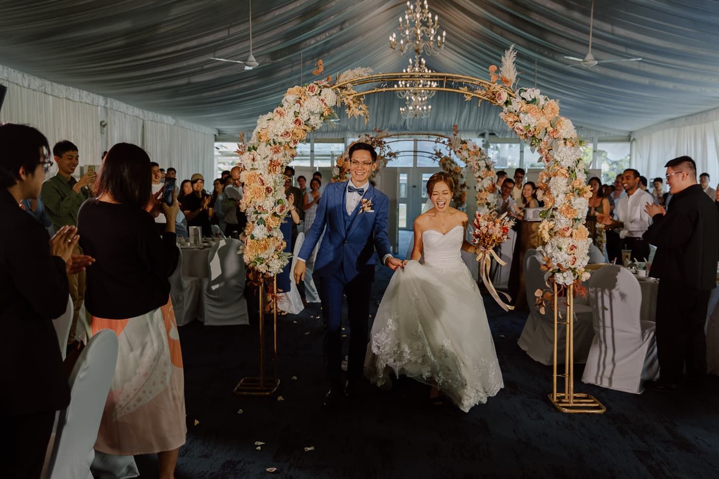 An elegant wedding reception setup with chandeliers and romantic lighting.