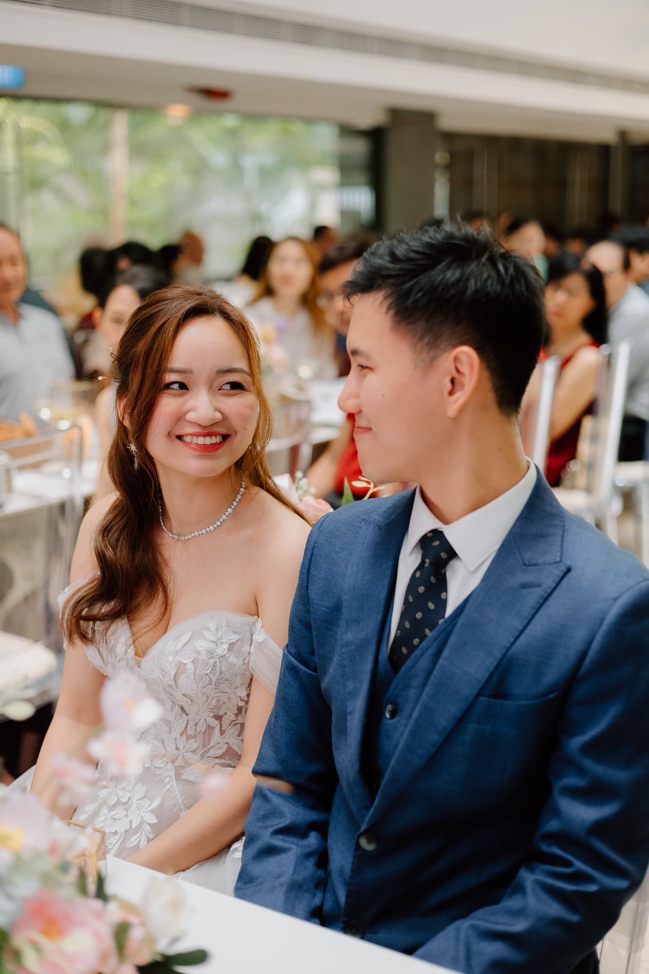 Wedding couple sharing a joyful moment during their reception celebration.