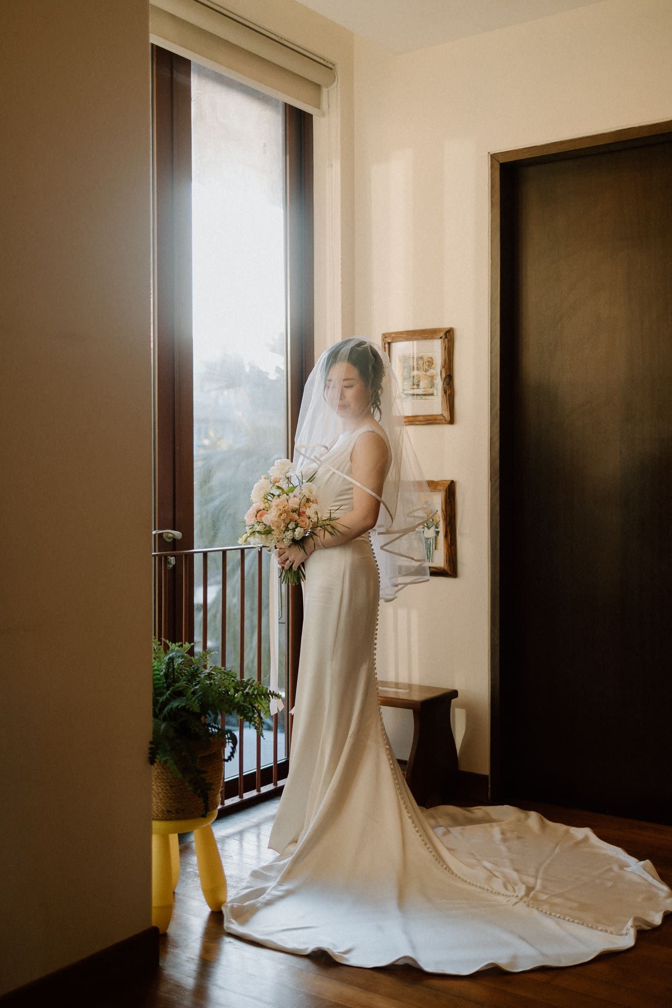 A sequence of wedding dress shots near a window with natural light streaming in and a trailing white gown.