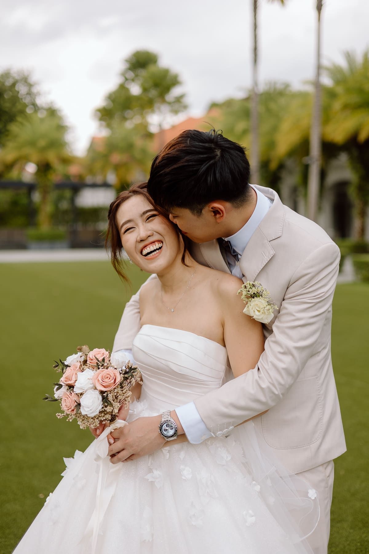 Joyful wedding moment captured outdoors with lush green scenery.