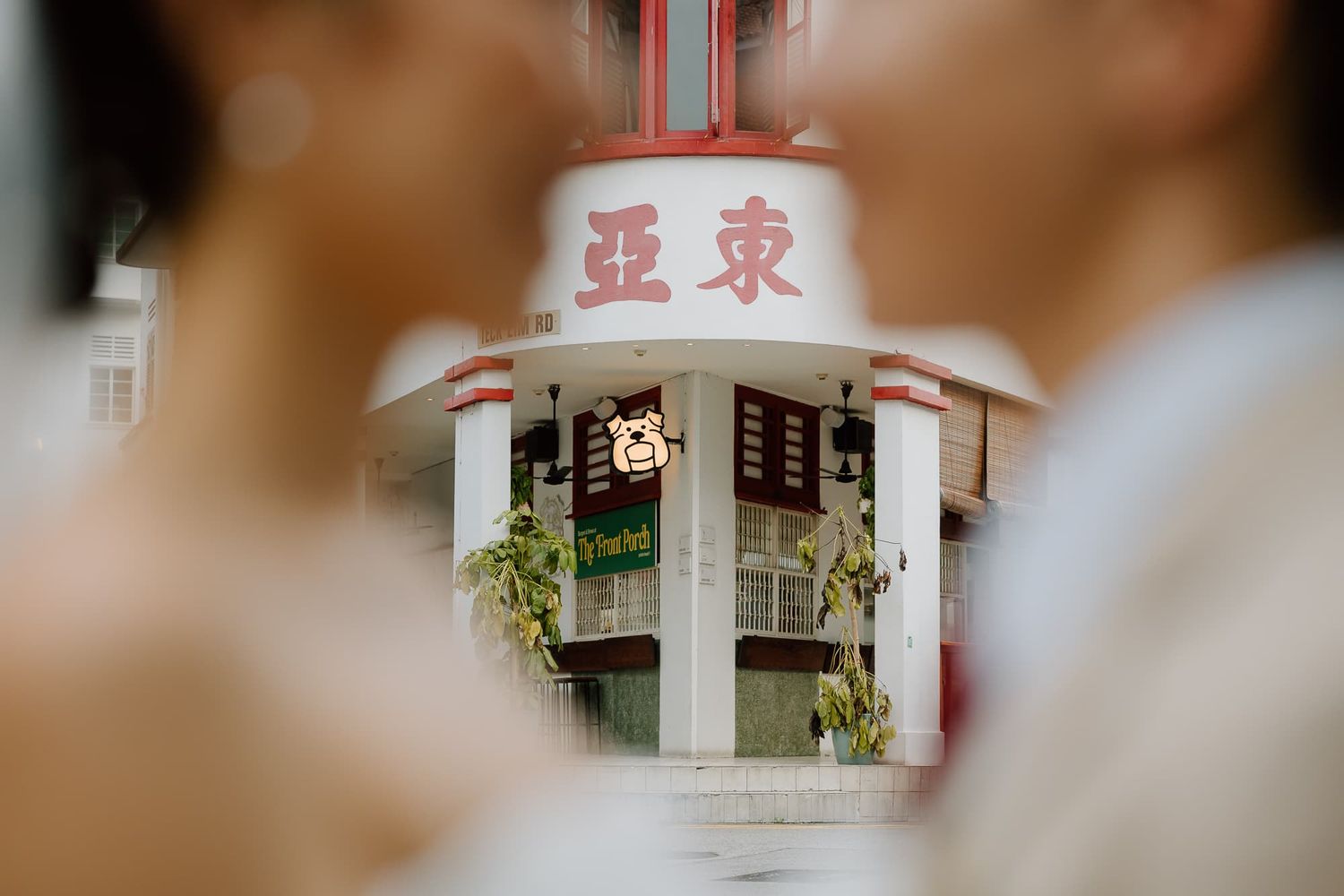 Blurred architectural details of a building with Chinese characters visible.