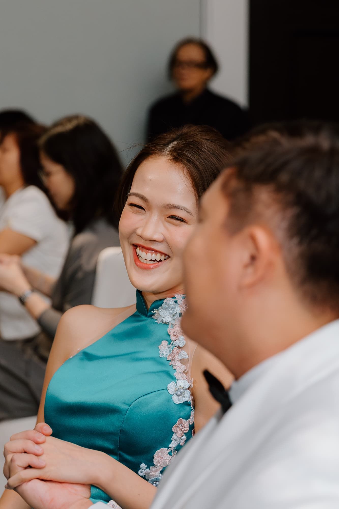 Joyful moment shared between couple in formal attire at wedding celebration.