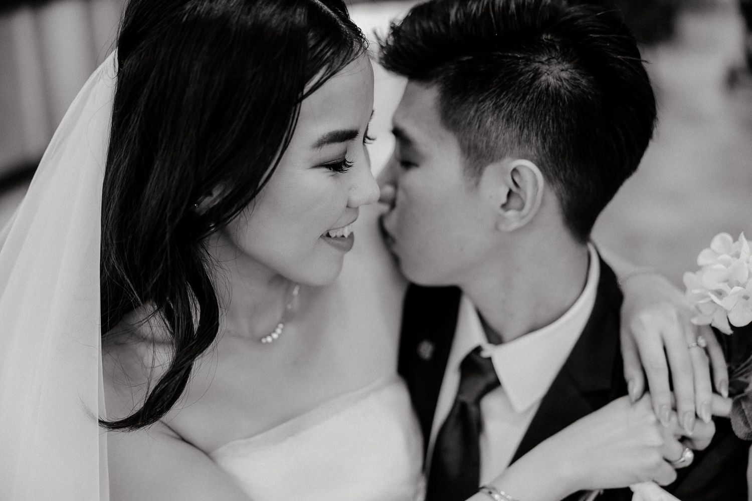 Black and white wedding portraits capturing romantic moments between the newlyweds.