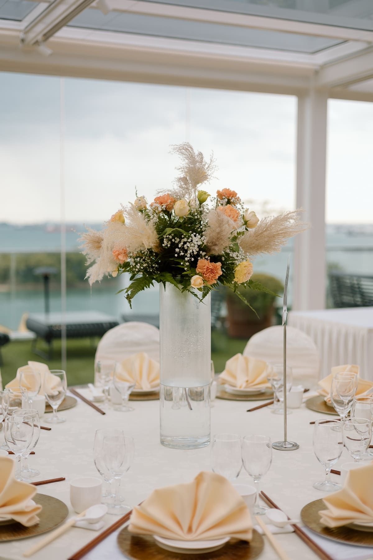 Wedding reception table setup with crisp white linens and delicate floral arrangements.