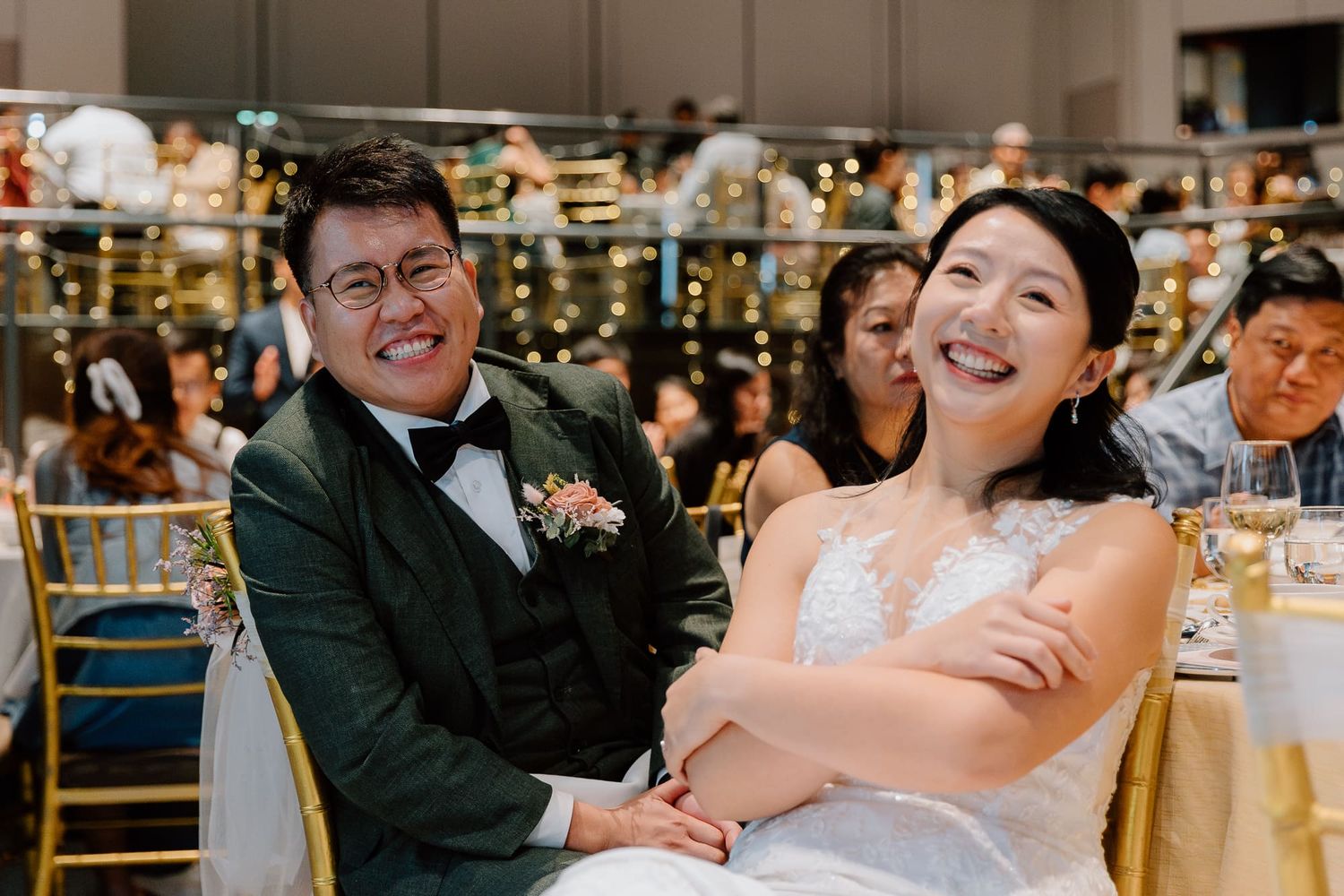 Joyful celebration moments captured during an elegant indoor wedding reception with warm lighting and festive atmosphere.