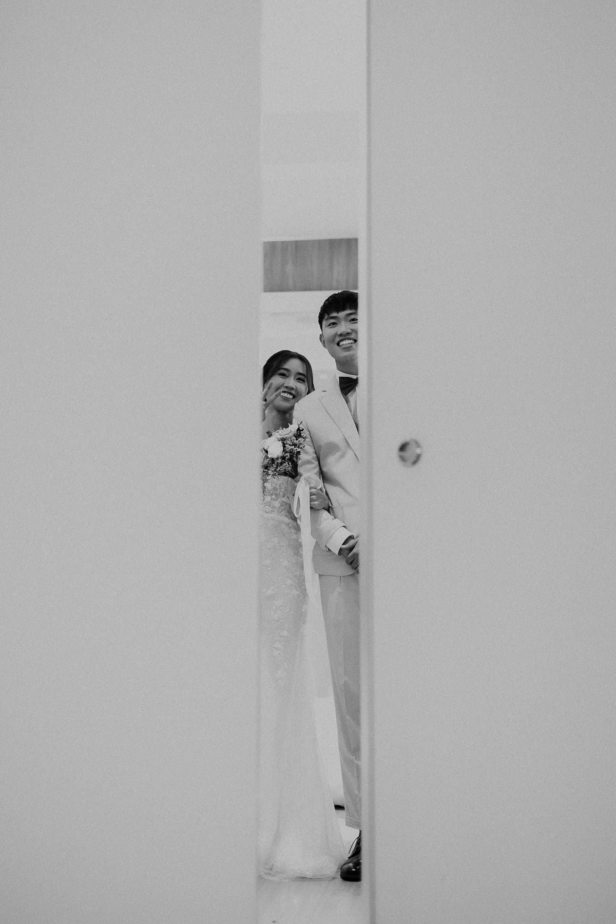 Artistic black and white shots of someone peeking through a narrow doorway or wall opening.
