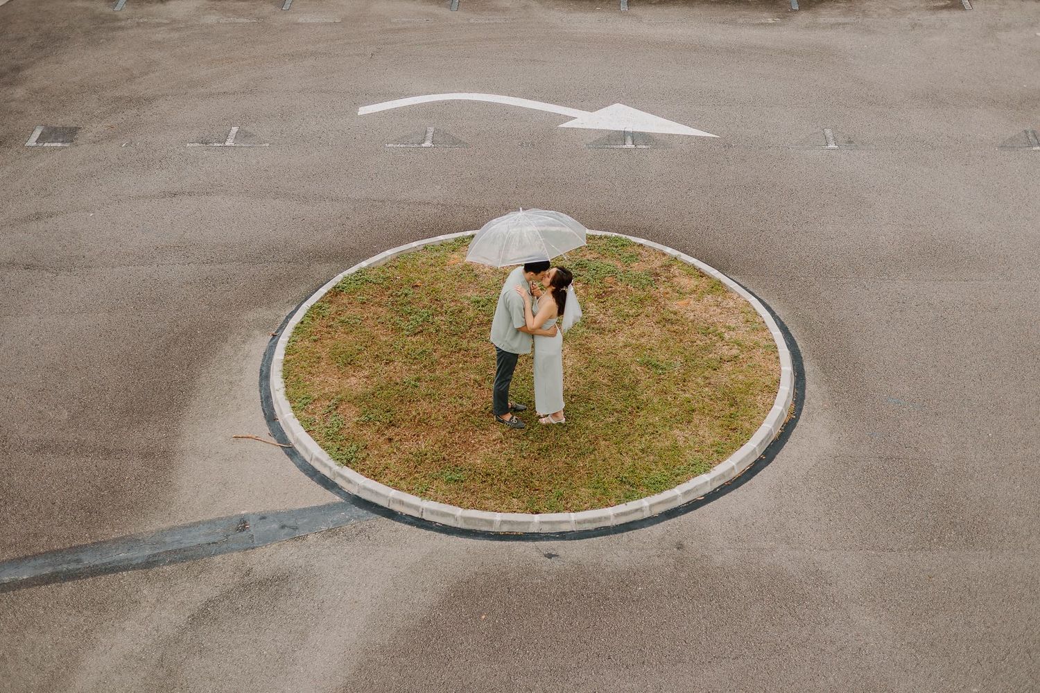 Wedding photo taken from above showing couple standing in a circular outdoor space.