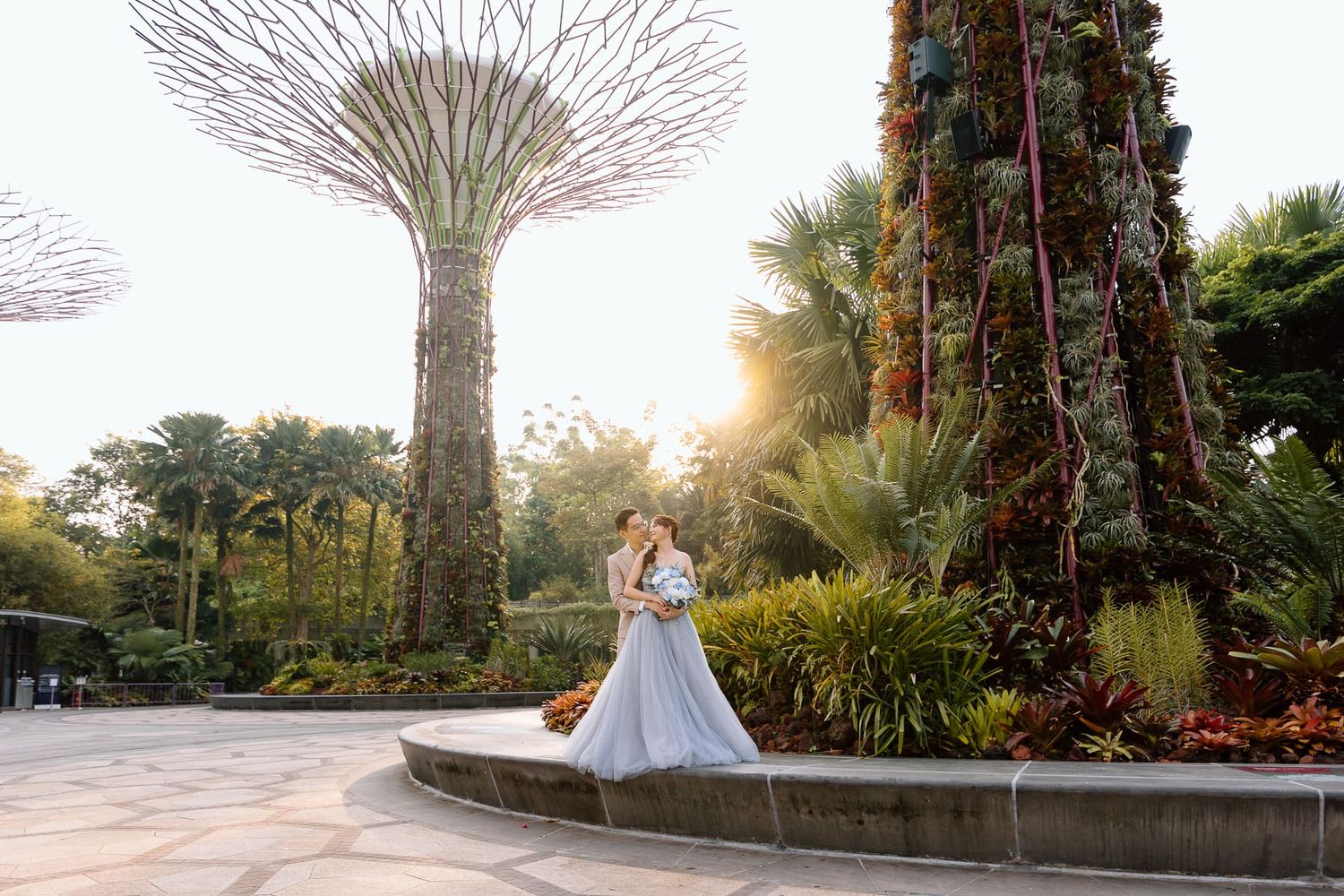 A wedding couple posing by the iconic Supertree Grove at Gardens by the Bay in Singapore.