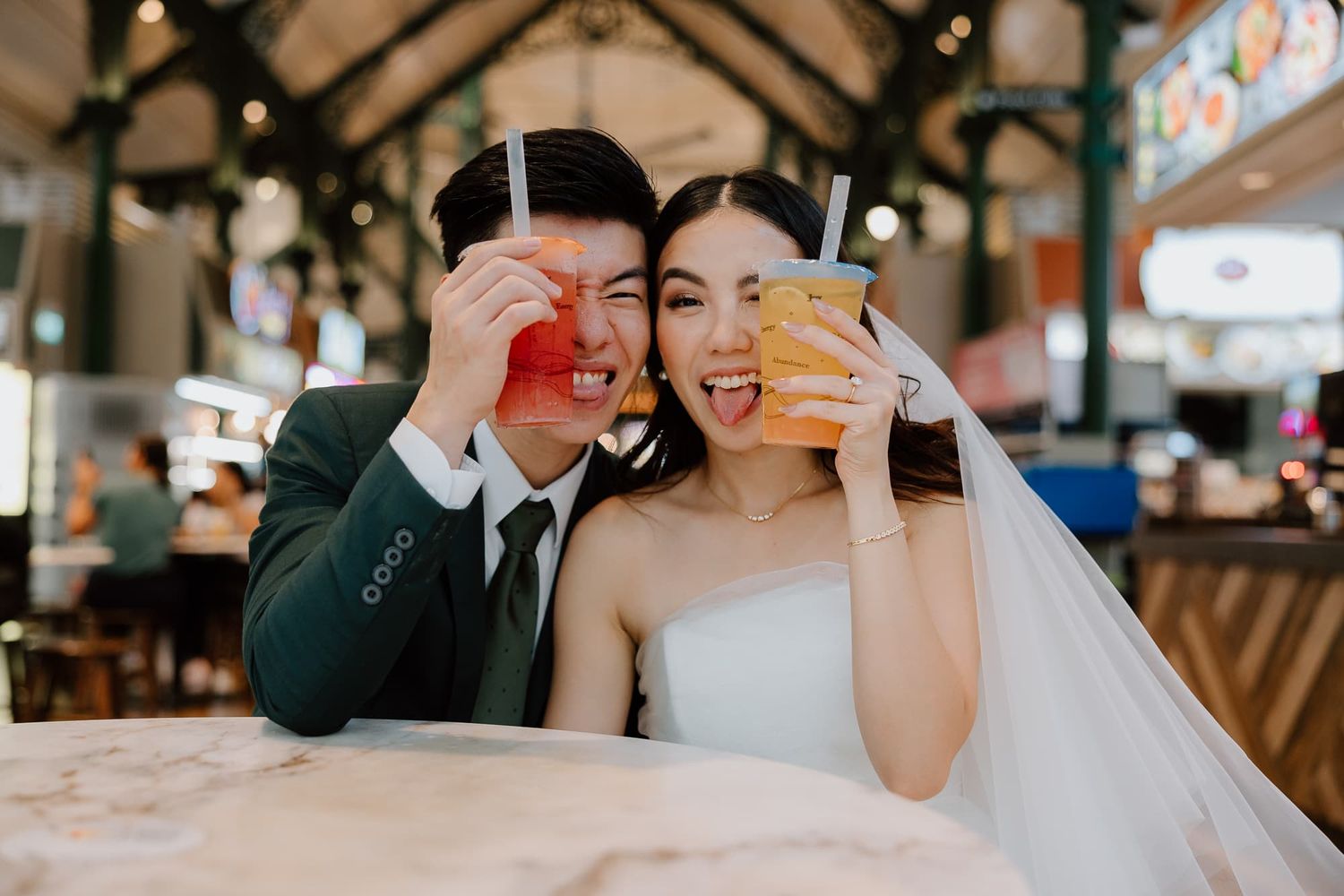 Fun wedding reception photos showing the couple playing with dessert decorations.