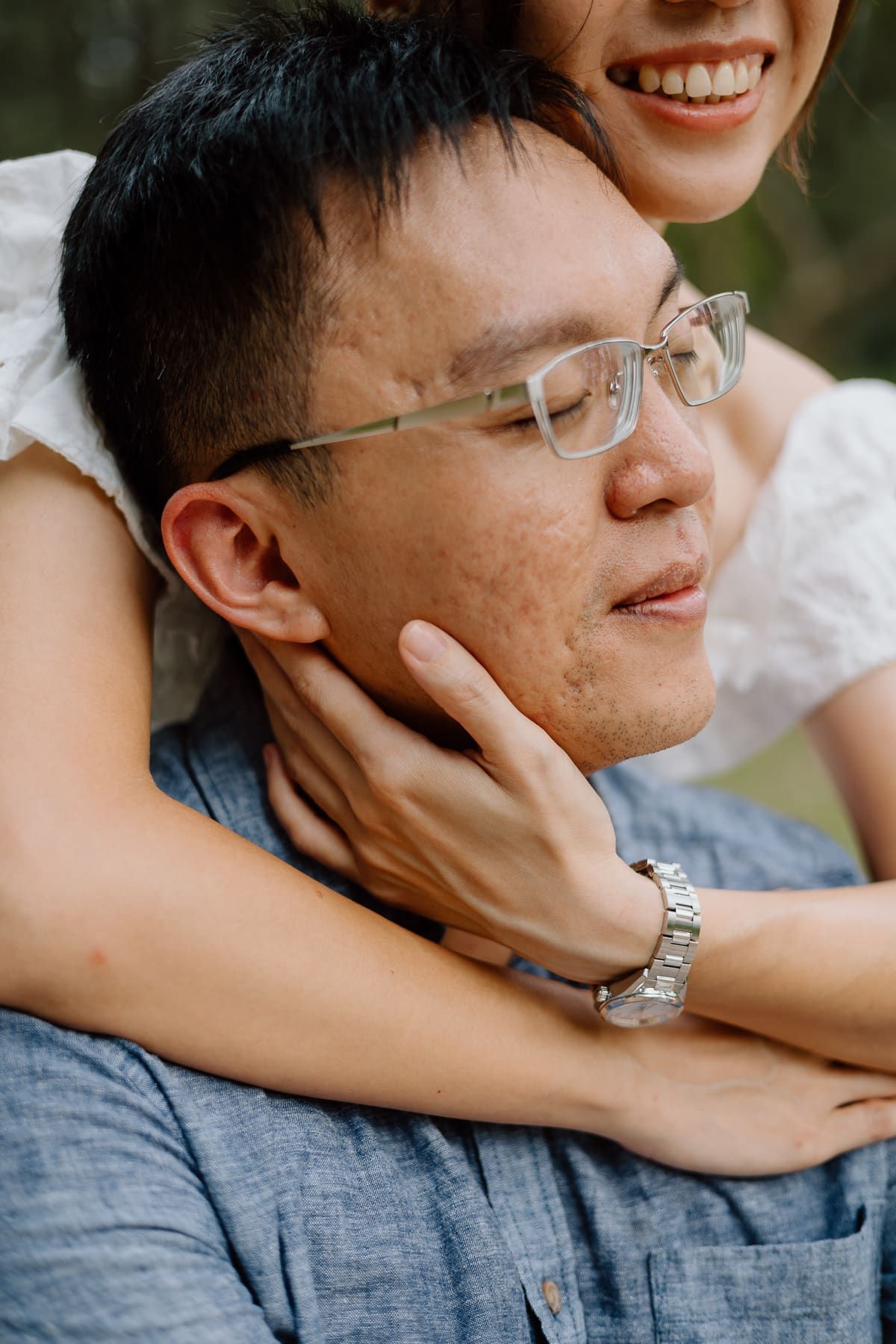 Close up photo of a tender romantic moment showing affection in a natural outdoor setting.
