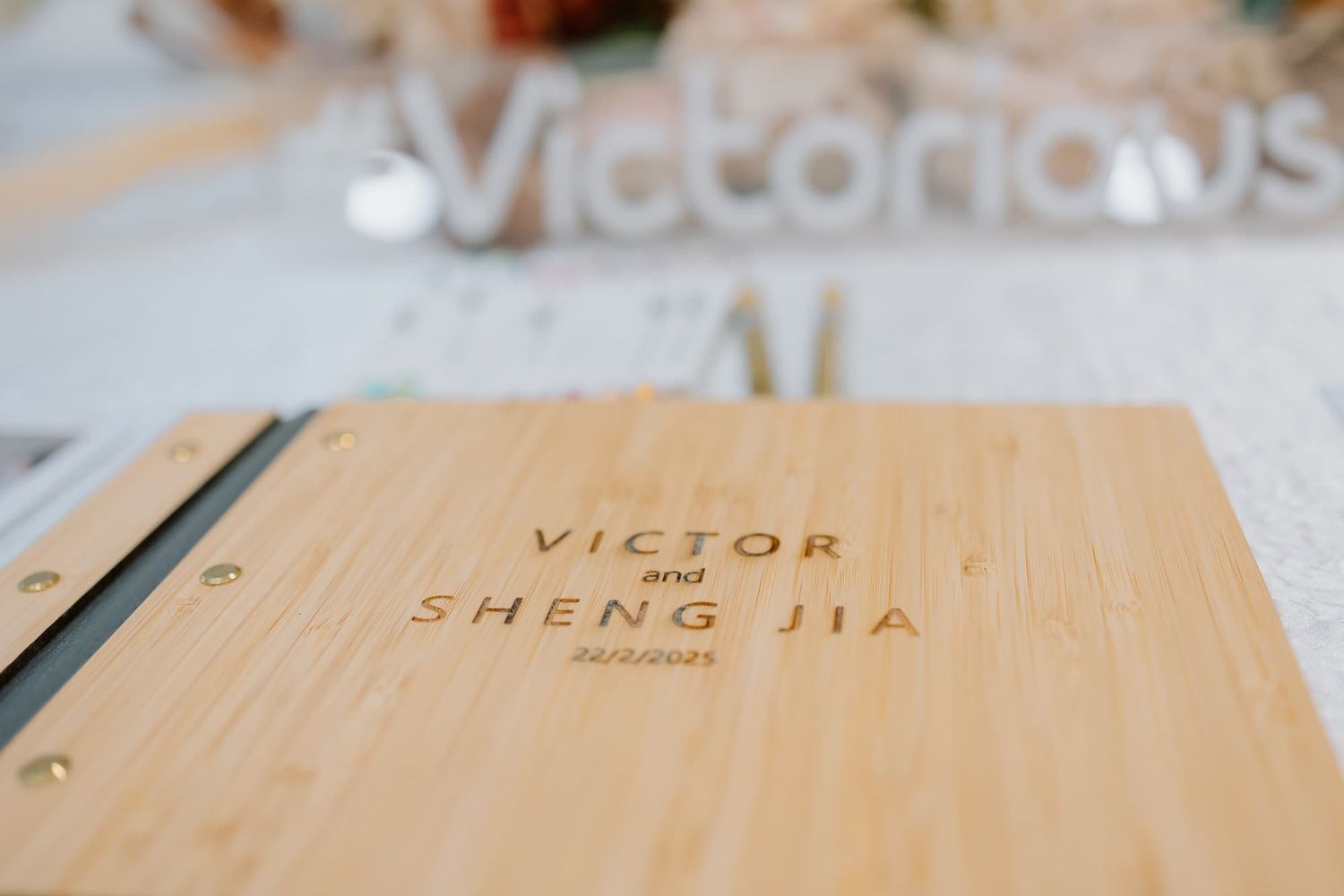 A wooden wedding guestbook with custom engraved names.