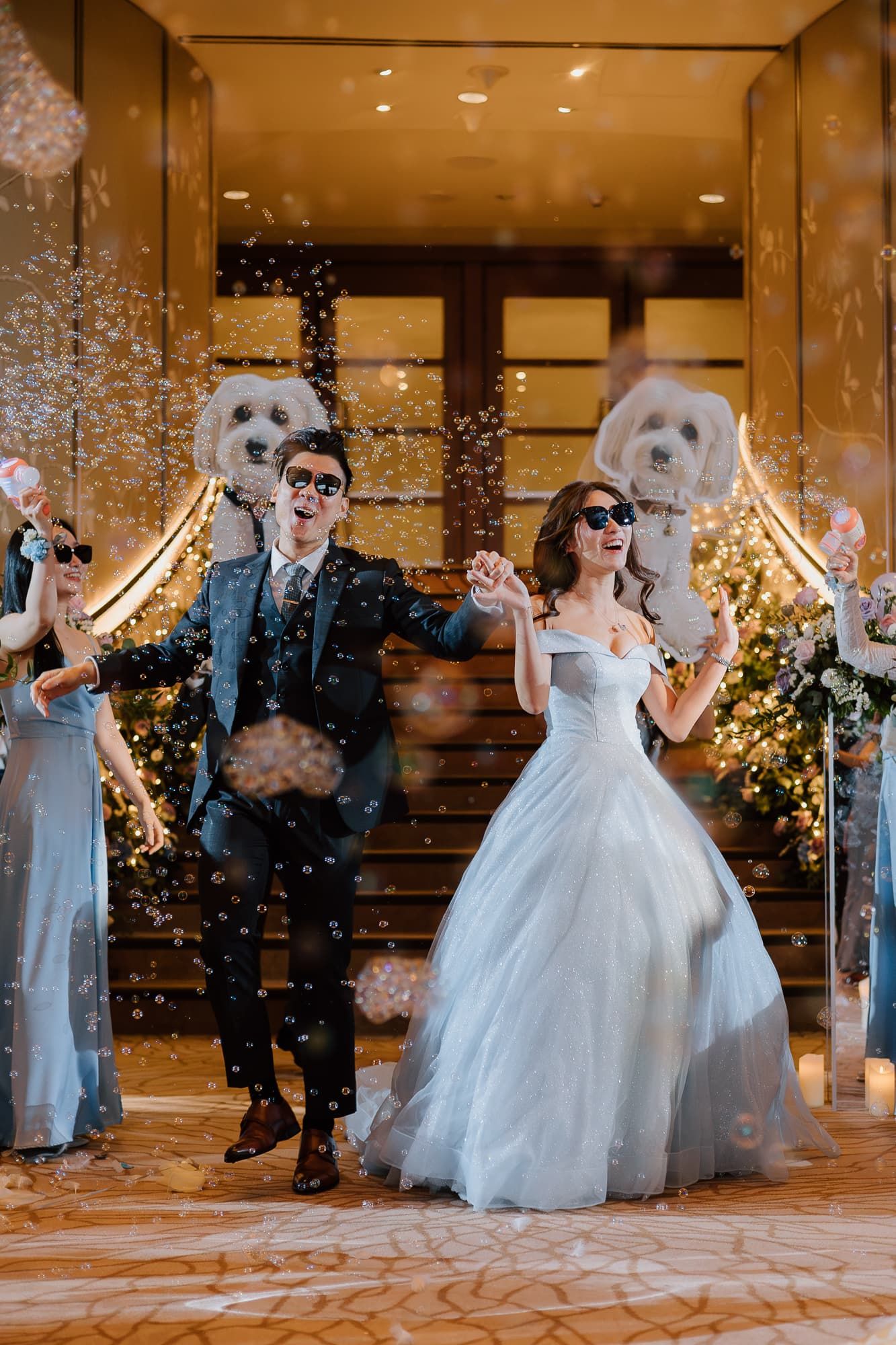 Festive wedding party dancing and celebrating with confetti and sparkles in an ornate venue.
