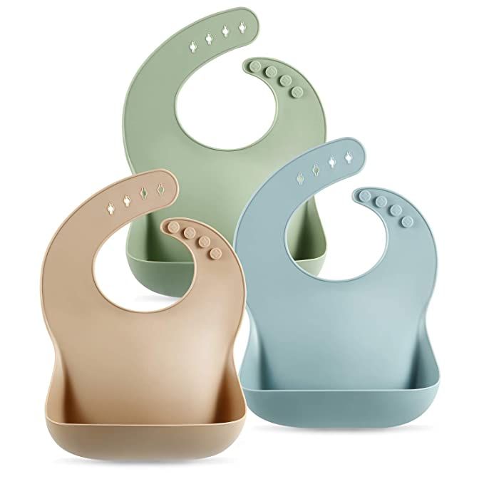 Three silicone baby bibs with food catchers in soft pastel green, beige and light blue colors.