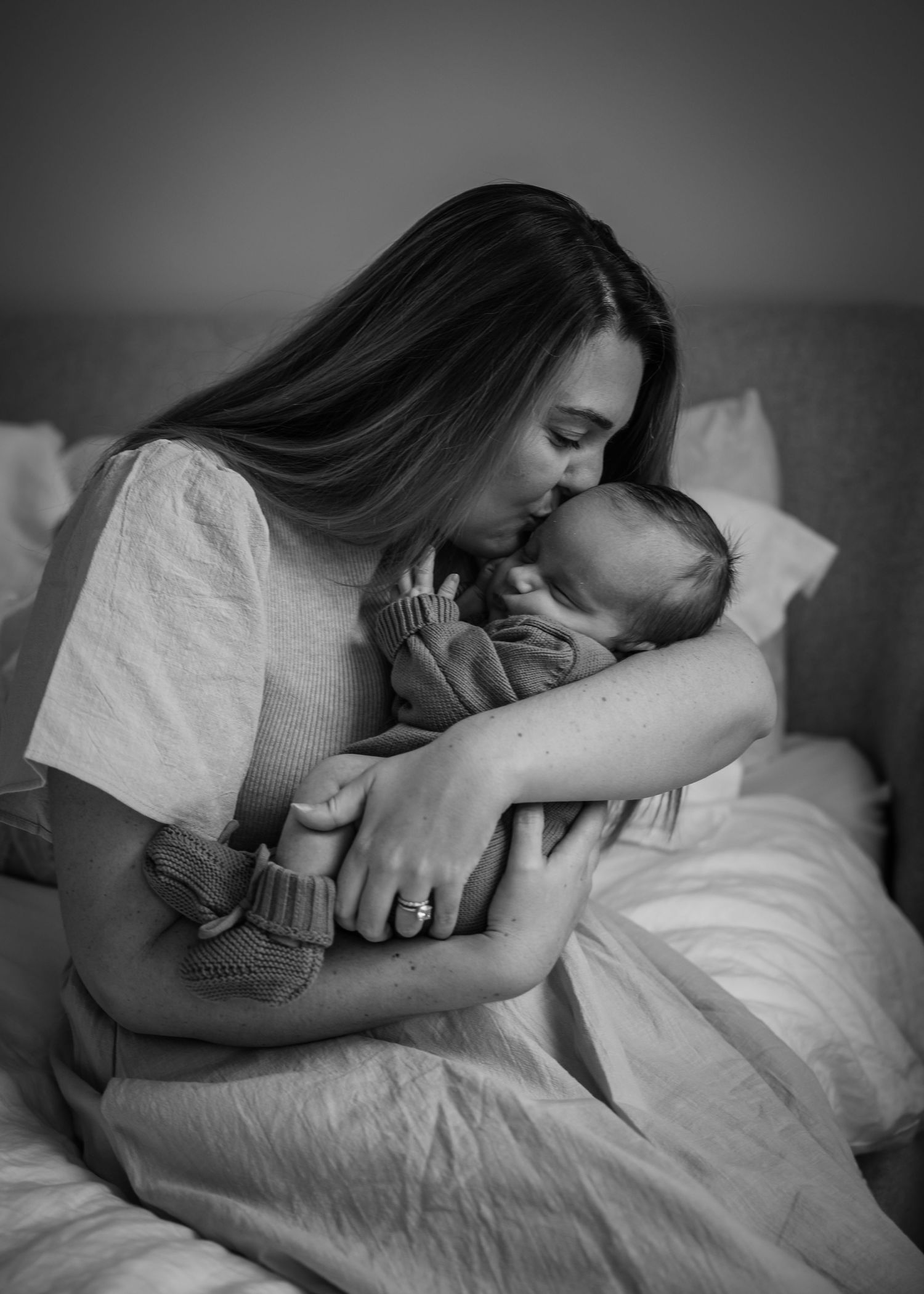 Black and white photos of person sleeping peacefully in cozy bedding.